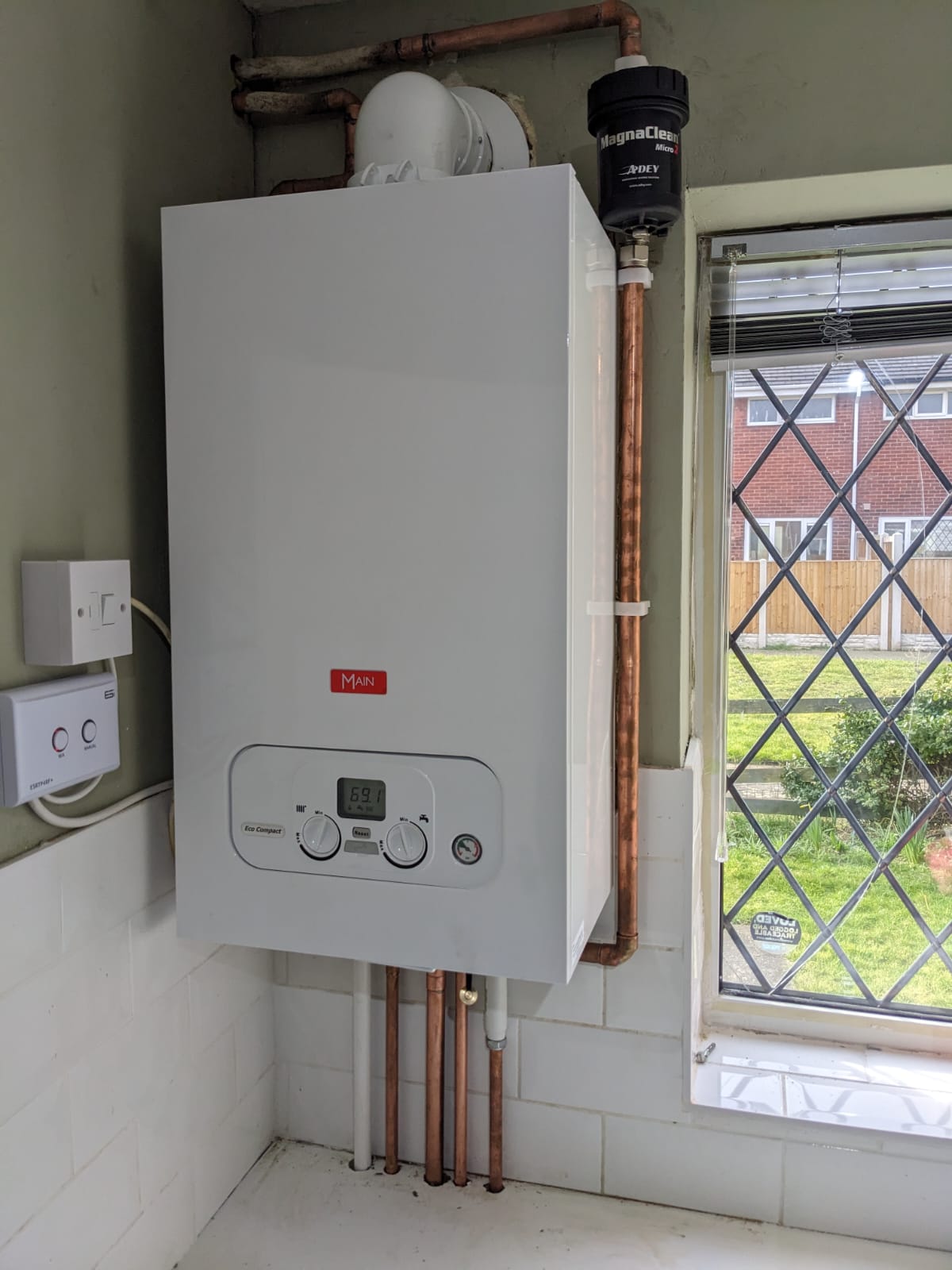 Completed boiler installation with heating system pipework