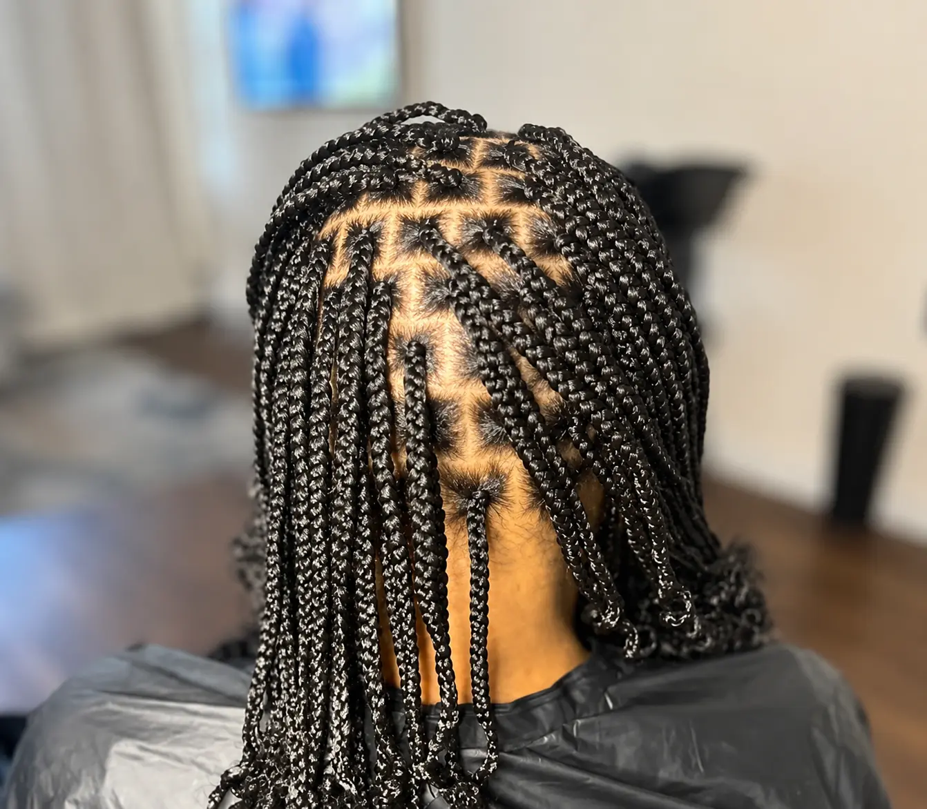 Tresses avec séparations en triangles, vue de dos