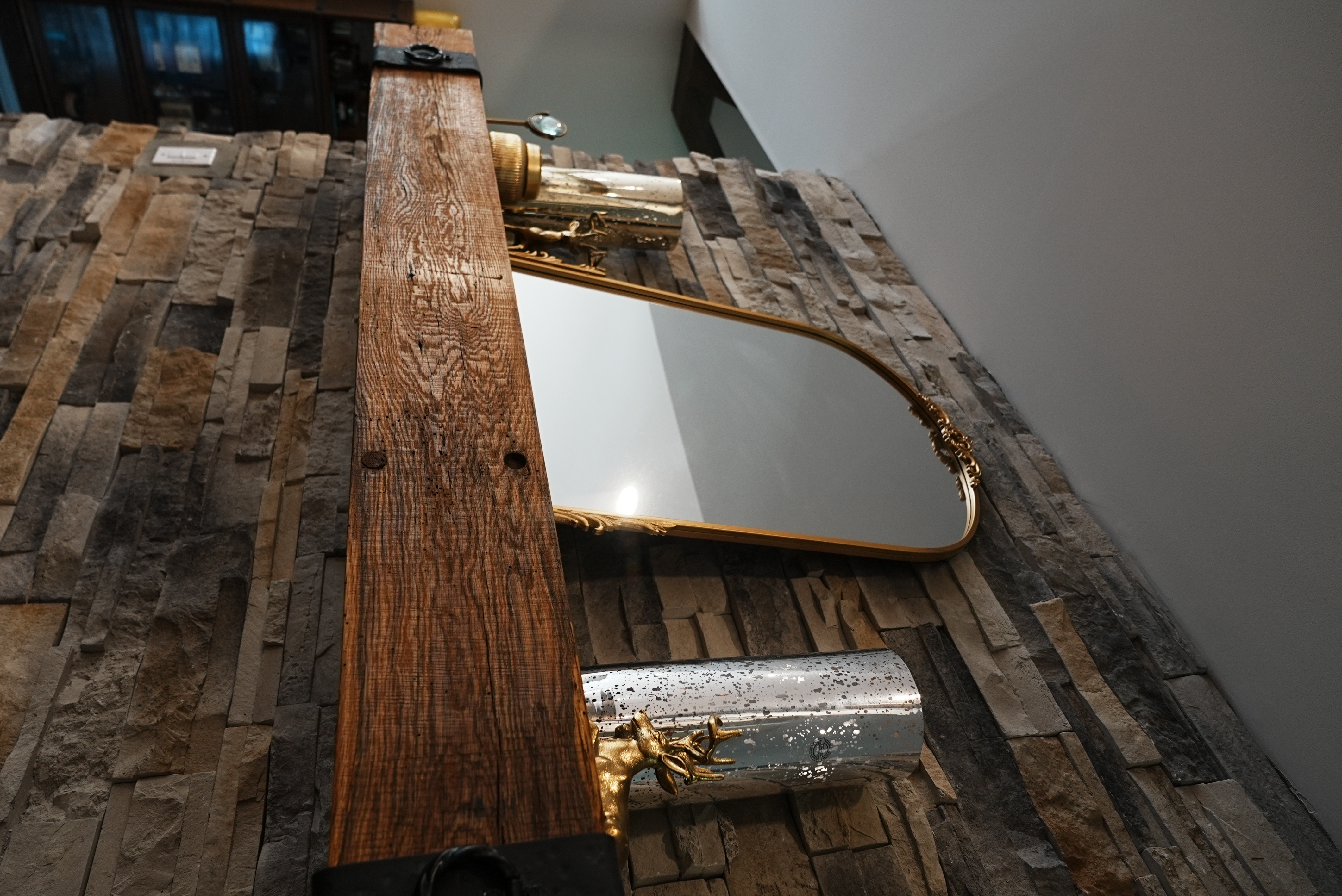 Stone fireplace mantel with rustic wood beam