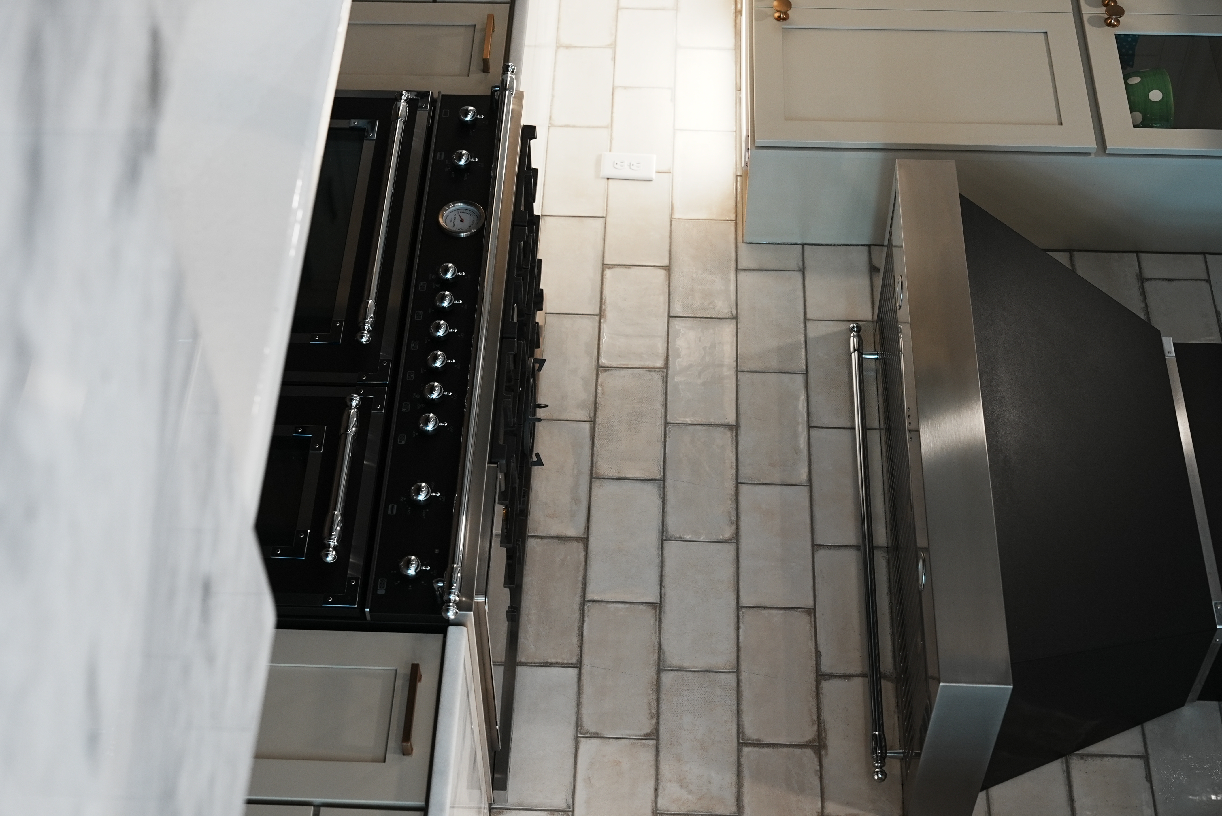 Chef's range with stainless hood and brick backsplash