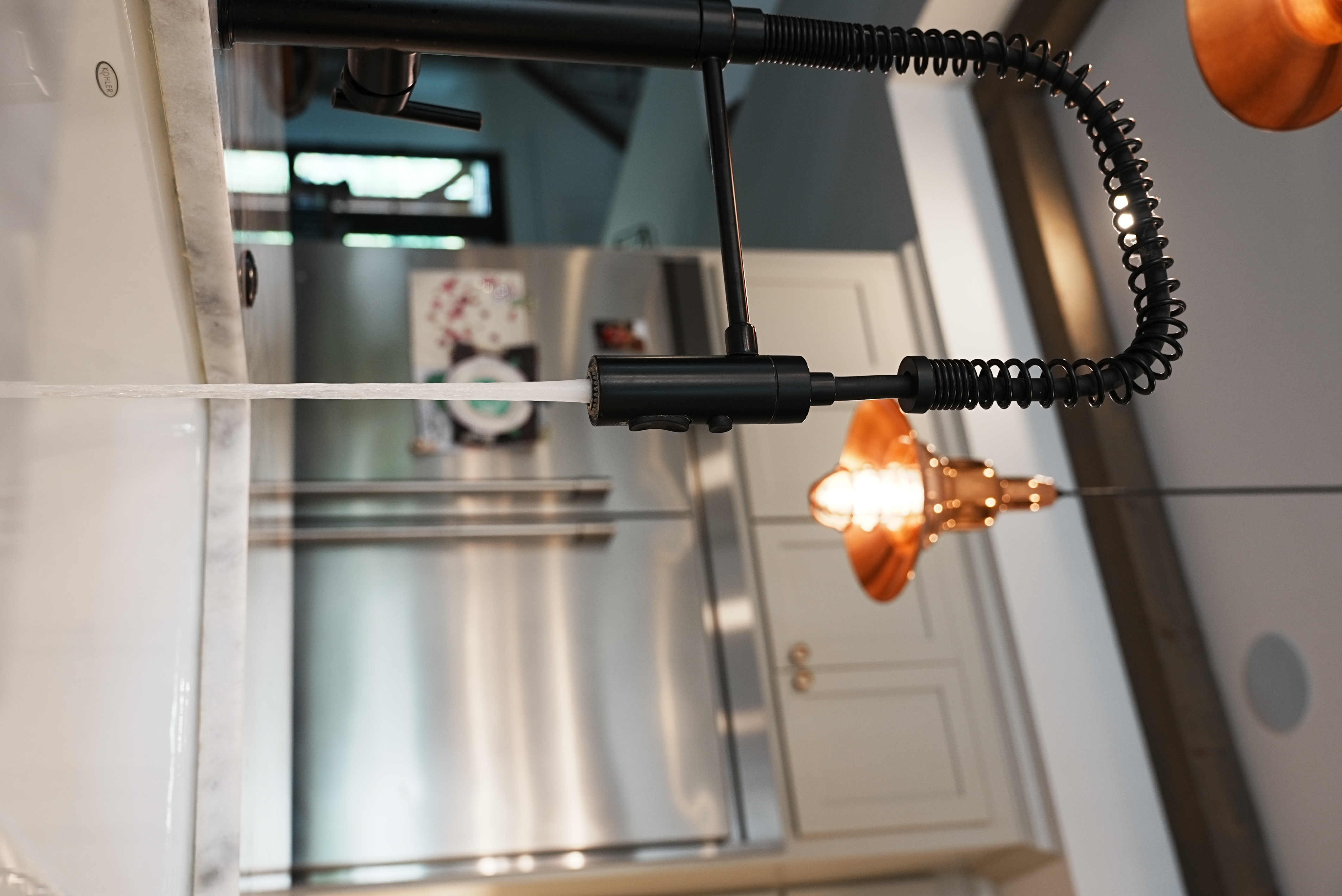 Kitchen faucet detail with stainless refrigerator