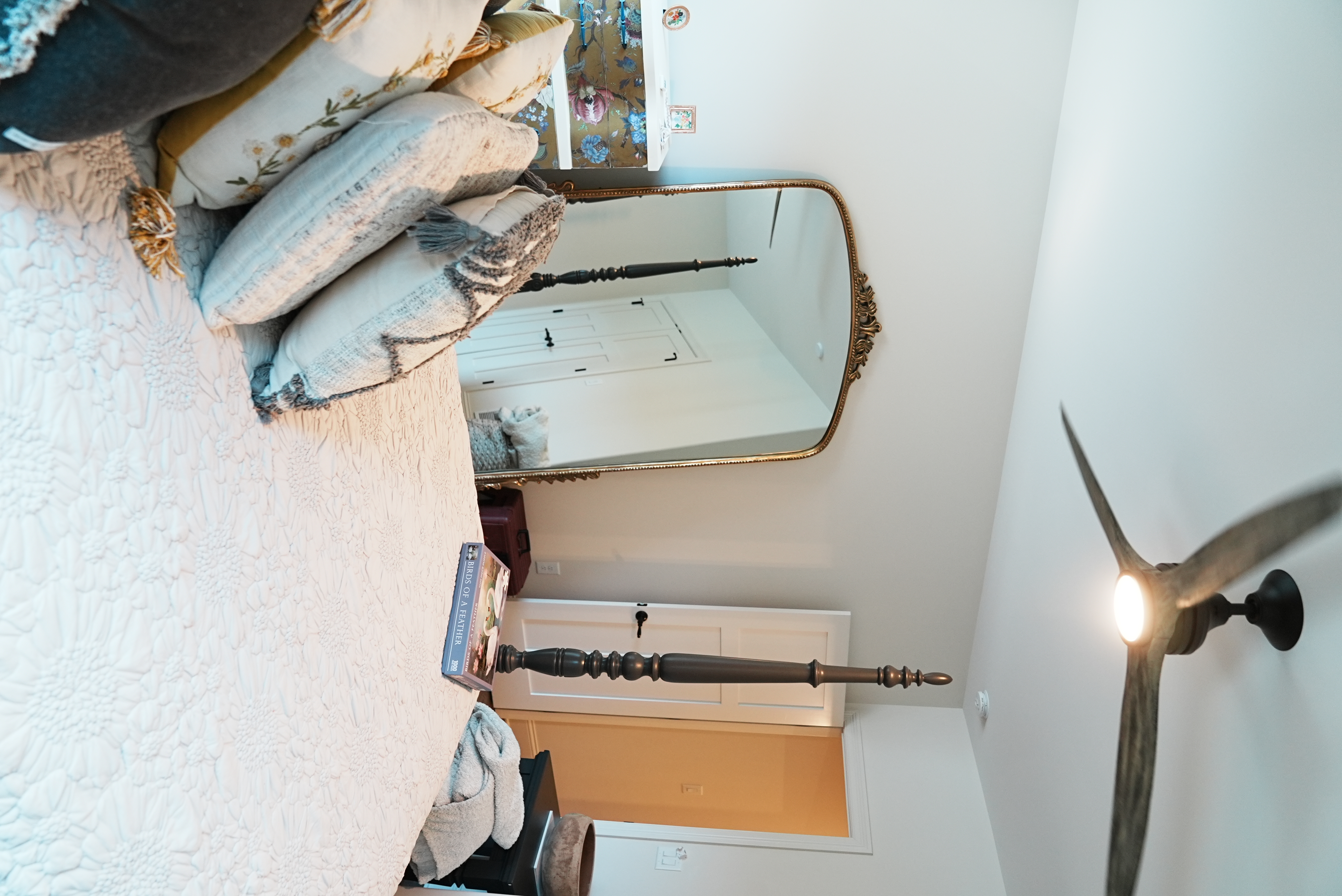 Bedroom with four-poster bed and full-length mirror