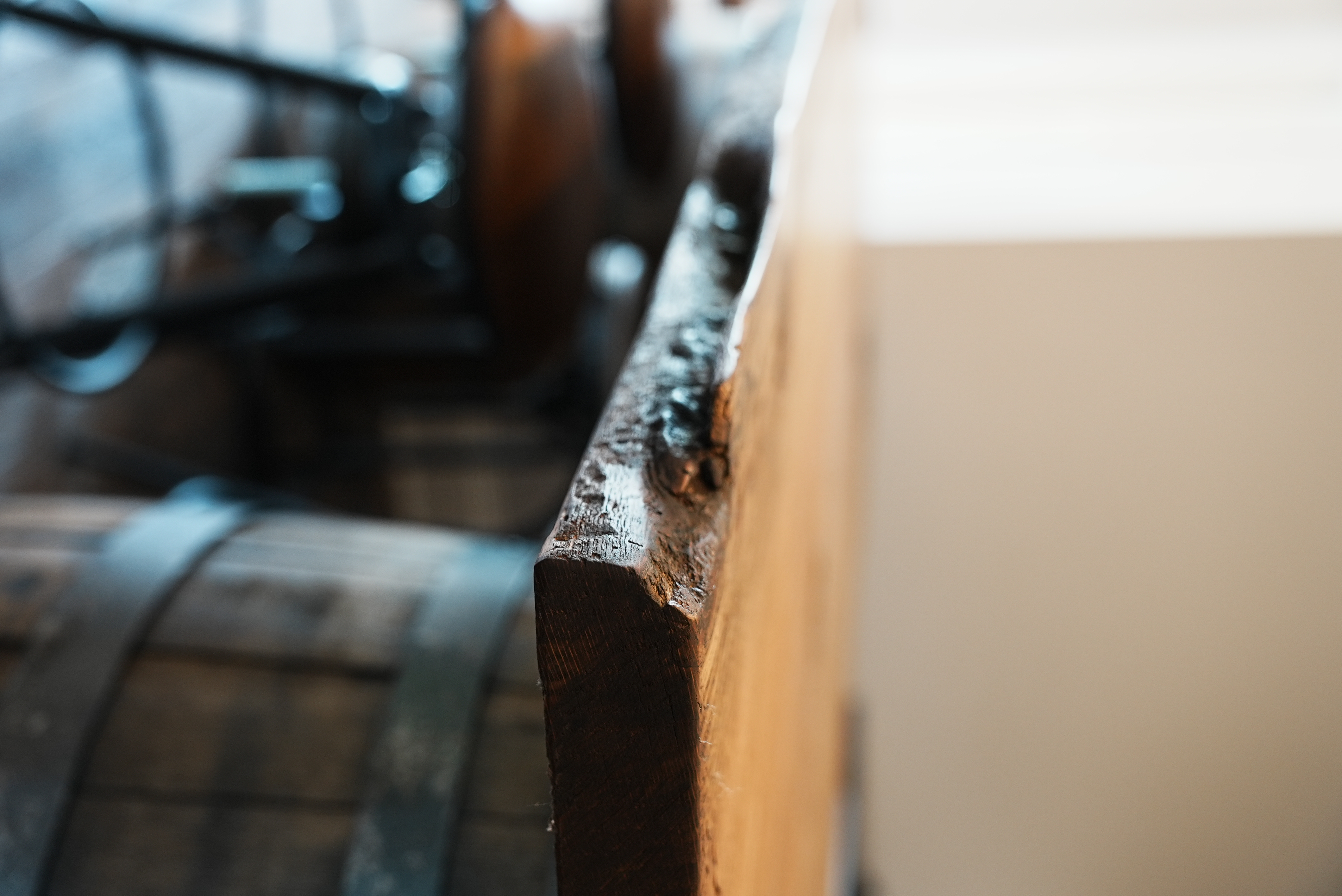 Live-edge wood bar top on a barrel base