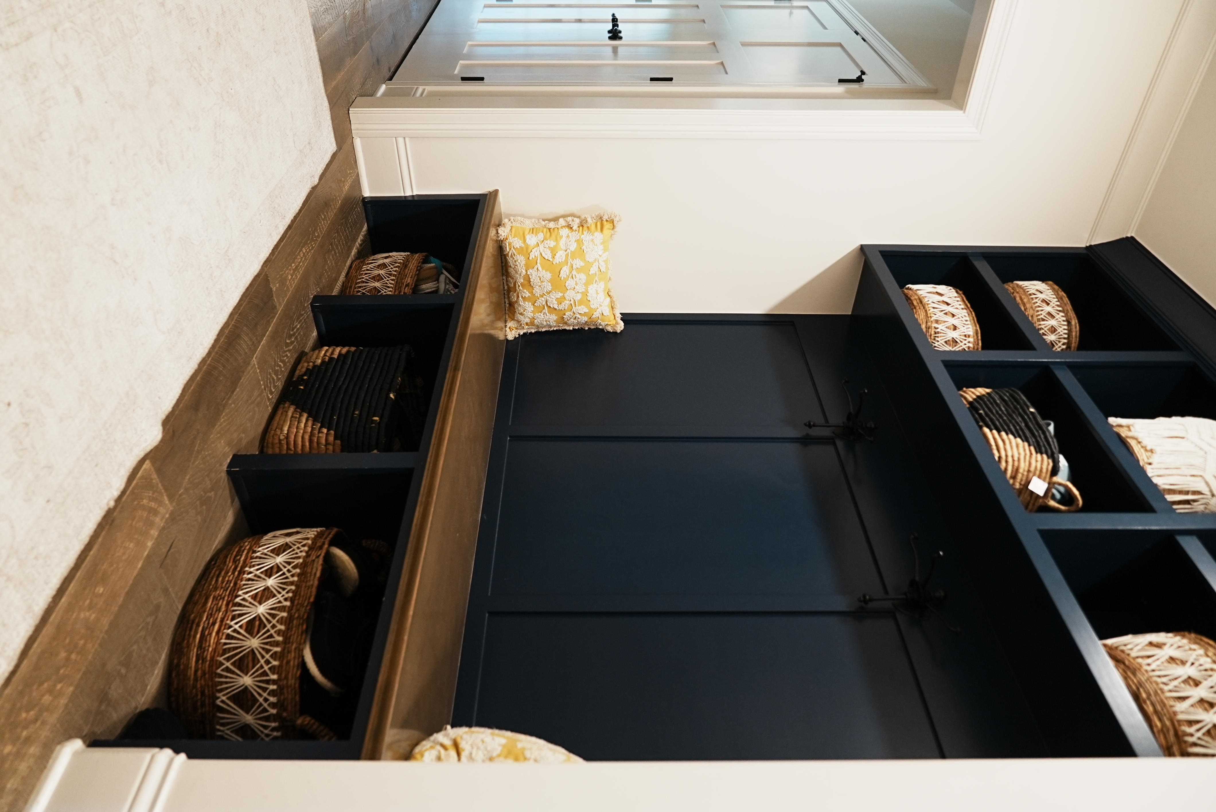 Mudroom with built-in navy lockers and bench