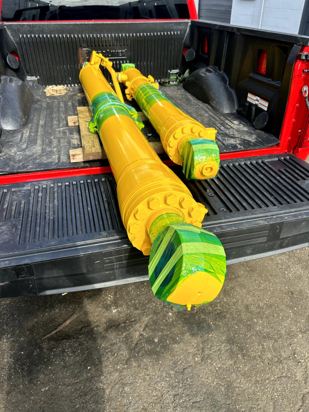 Wrapped hydraulic cylinders loaded in a truck bed