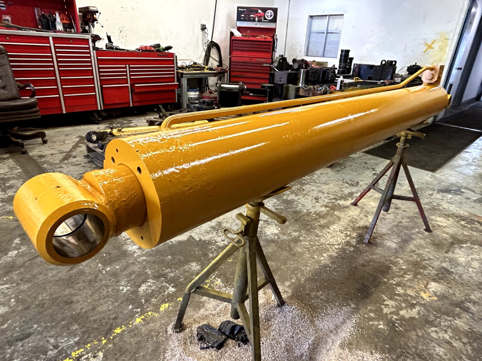Large hydraulic cylinder on stands in the shop after repair