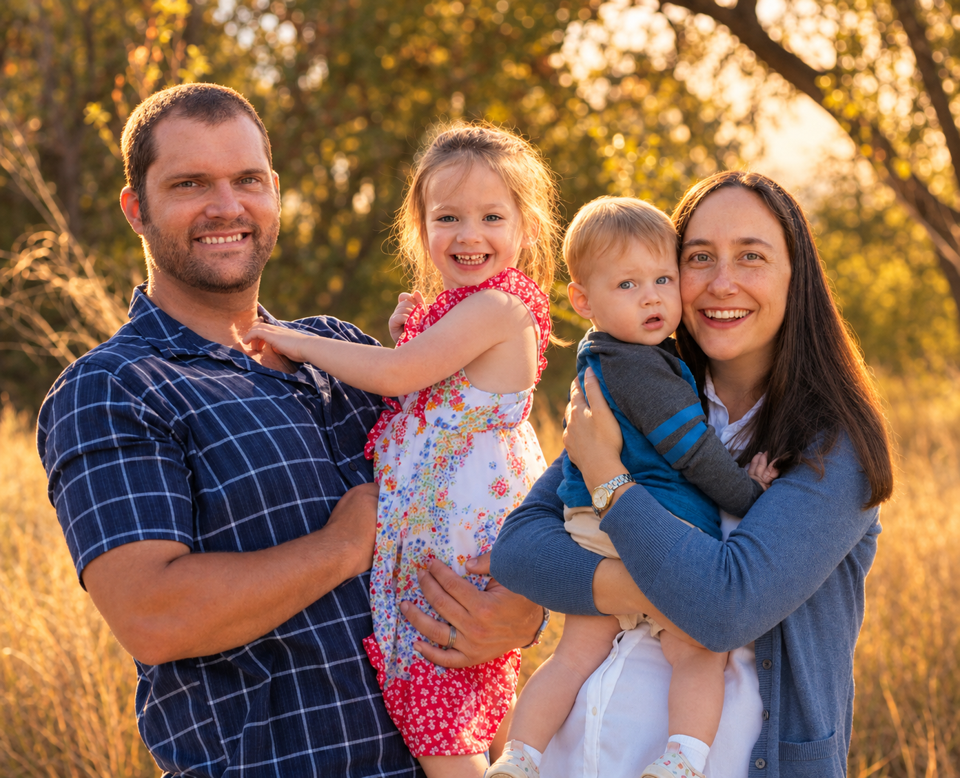 Family of four laughing together in warm evening light during a fall family portrait session in Albuquerque, New Mexico Family of four laughing together in warm evening light during a fall family portrait session in Albuquerque, New Mexico