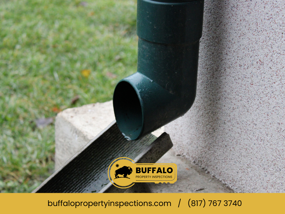 Detached downspout next to the gutter system.