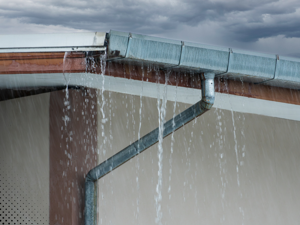 Water leaking from the gutter, indicating potential drainage issues.
