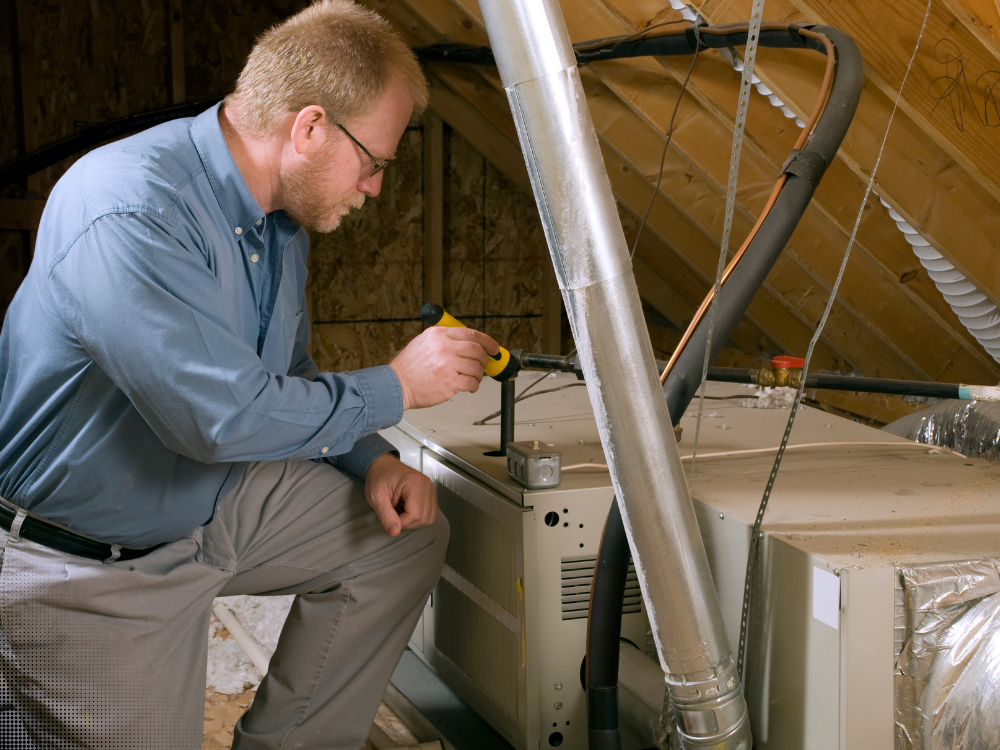 Home inspector evaluating attic HVAC furnace system and ductwork during a home inspection in Frisco Texas