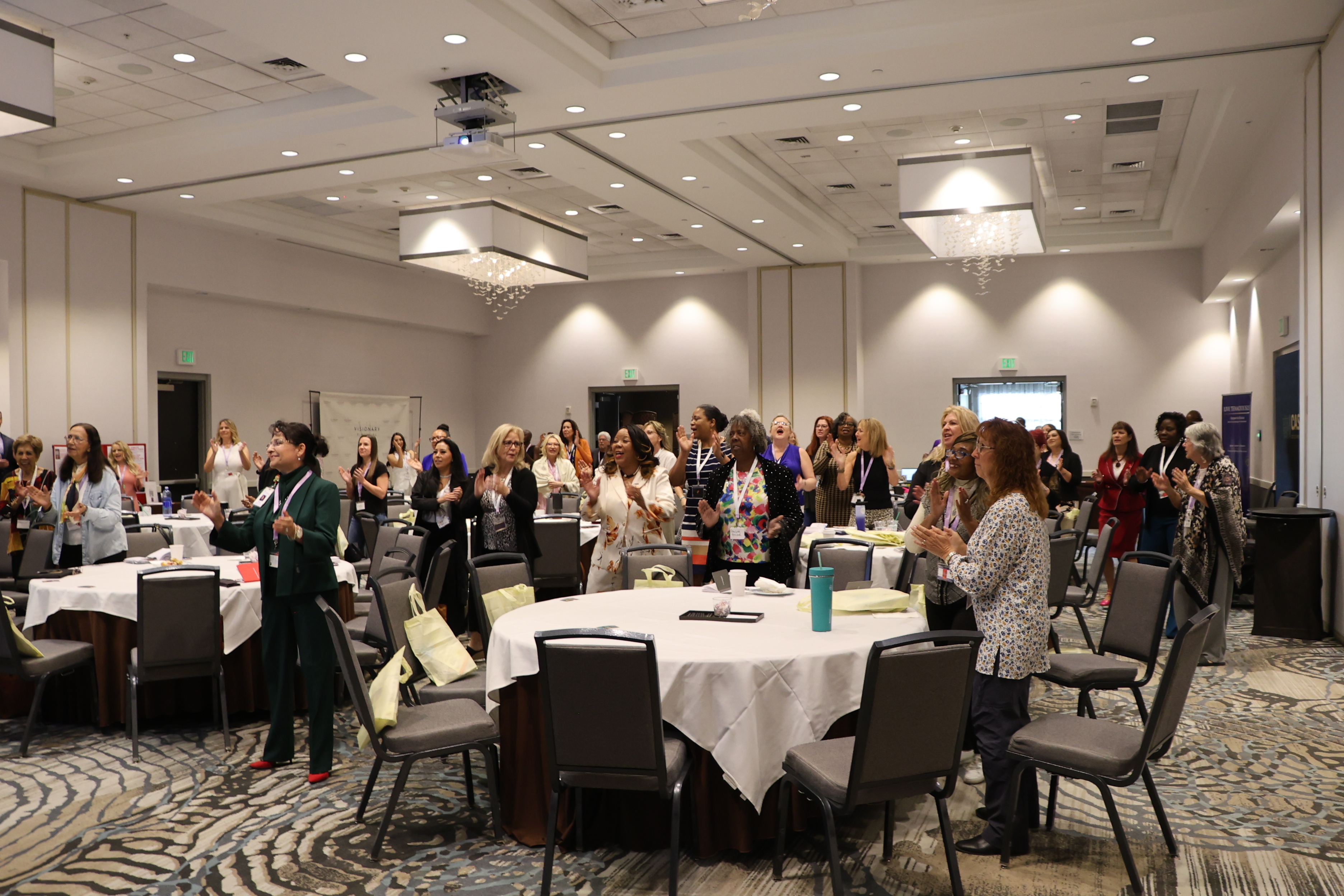 Professional leadership event with attendees gathered for connection and impact.