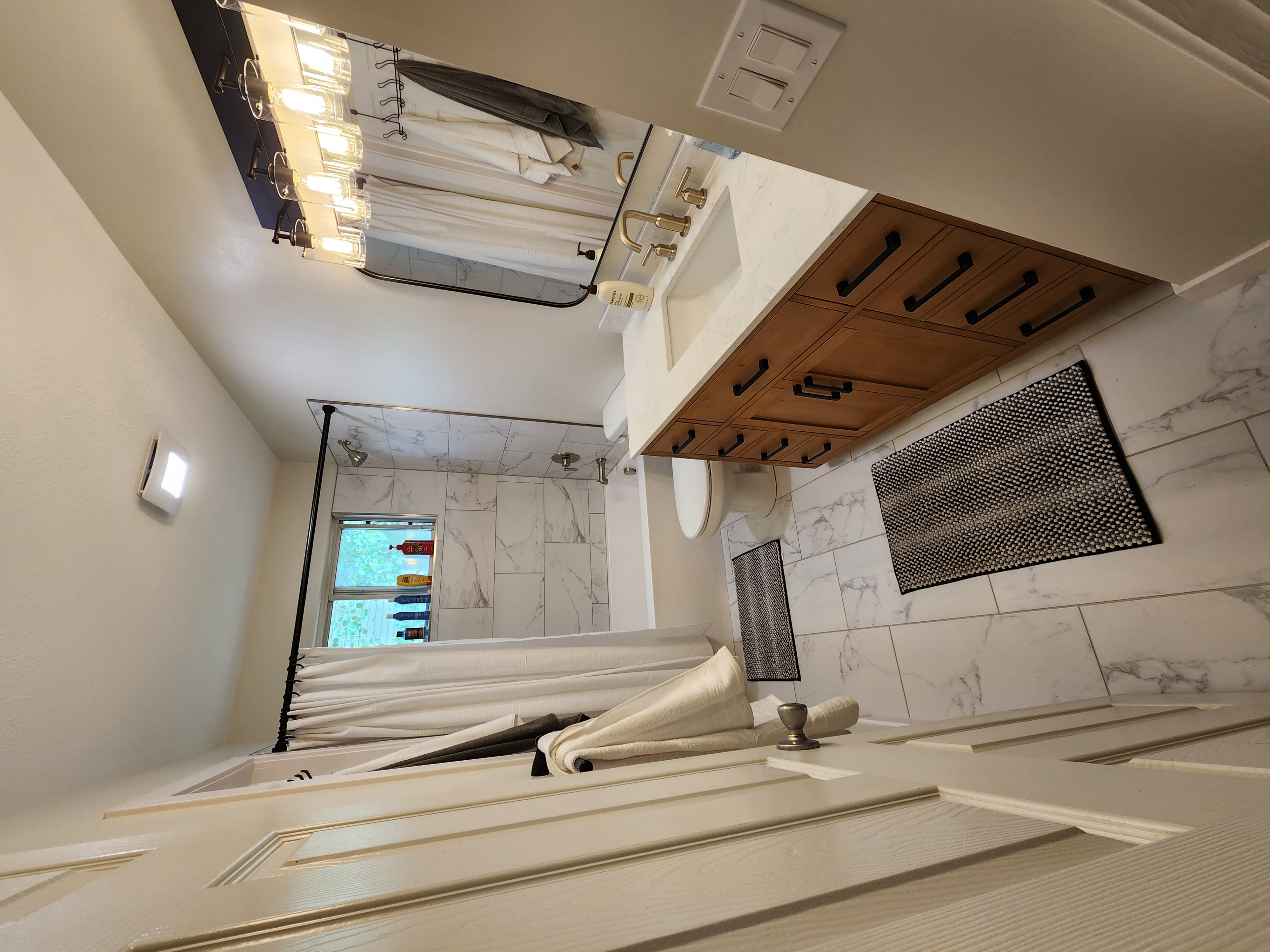 Bathroom with tile, a shower curtain, and a wood vanity