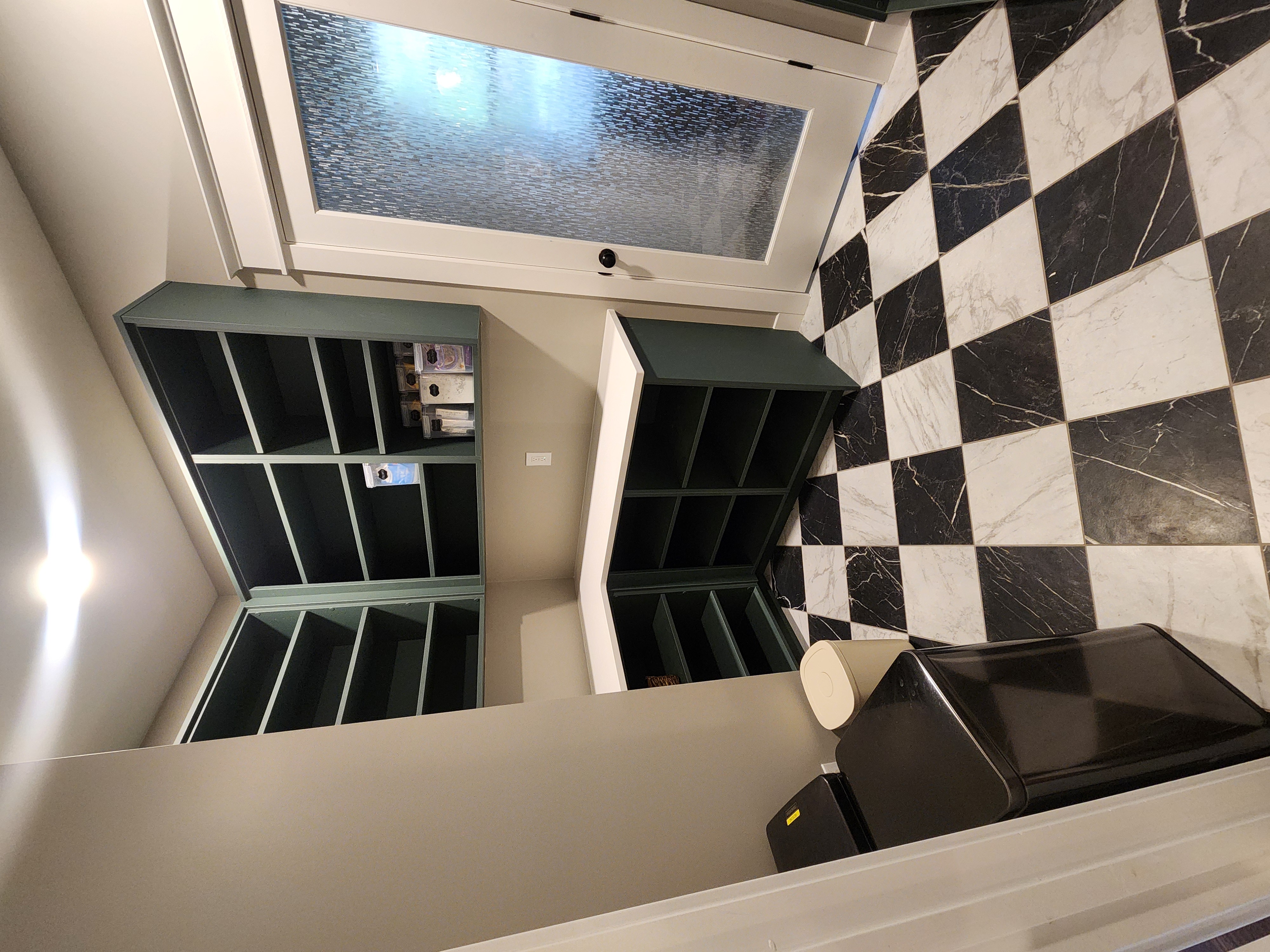 Pantry with green cabinets, installed white countertops, and checkerboard tile floor