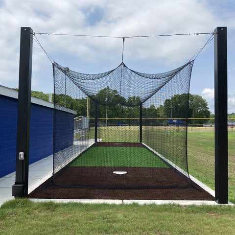 Backyard batting cage with custom netting and a turf floor at a family home in Texas