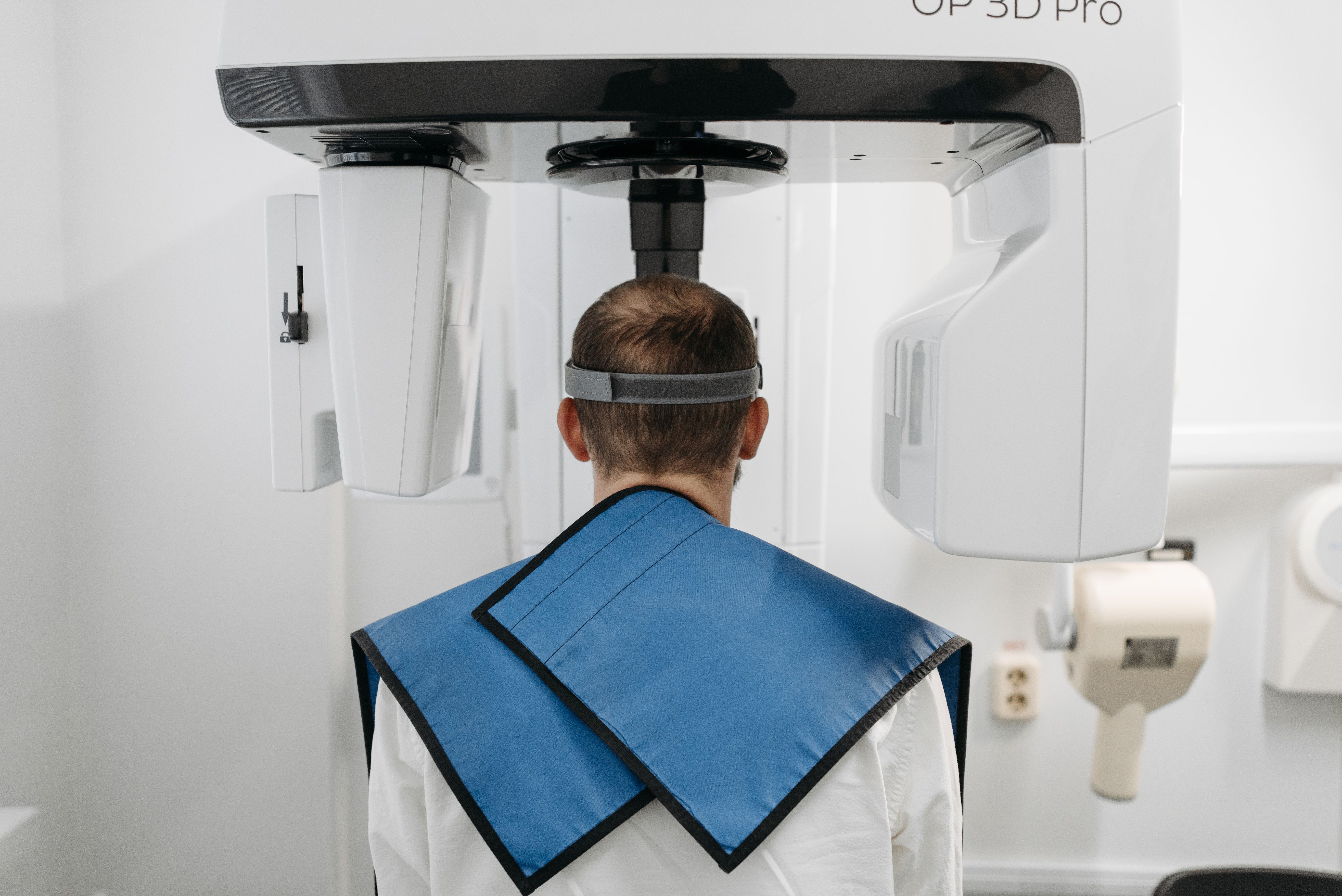 A patient taking a 3D scan with a Trinity Dental Arts team member