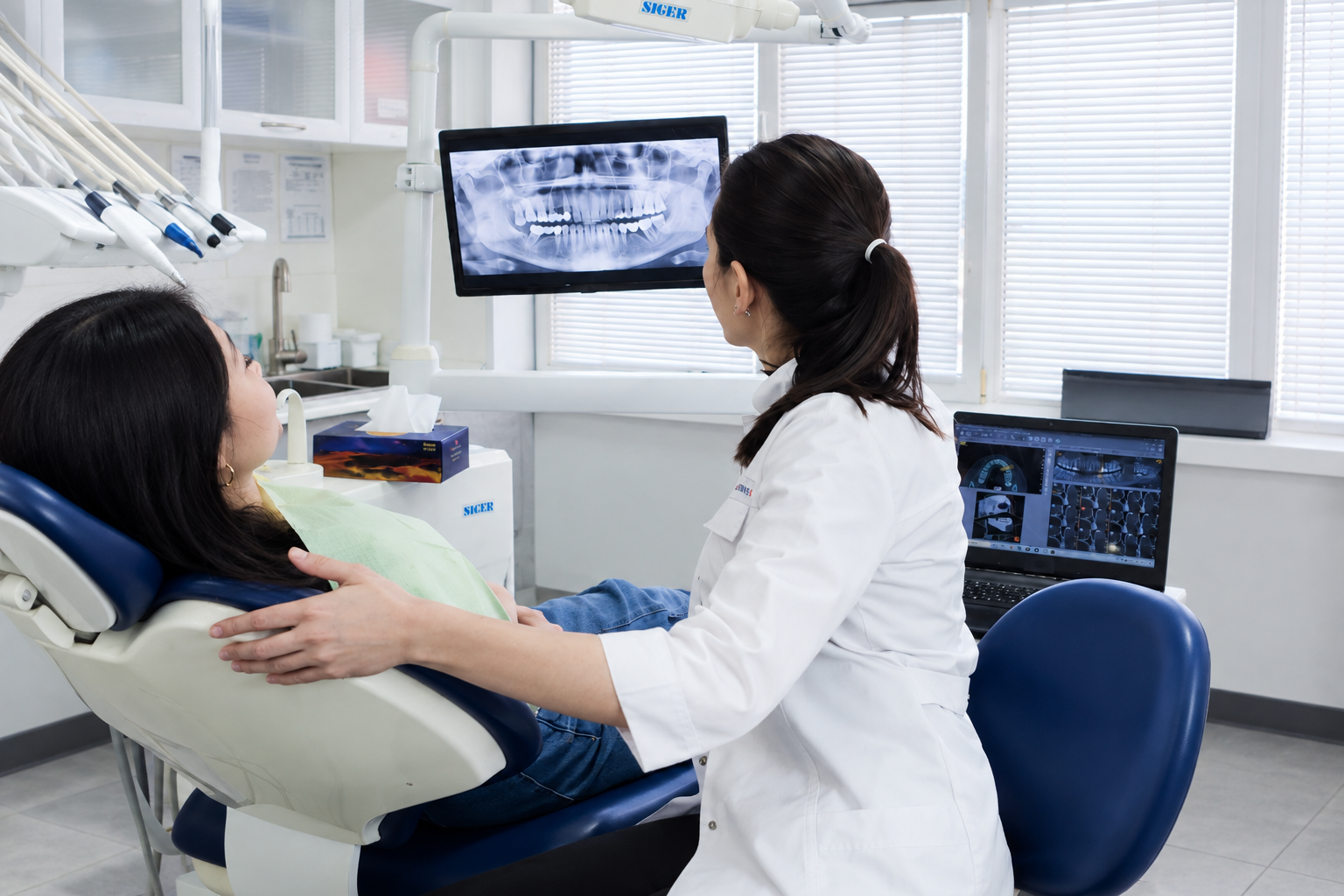 A patient in the Trinity Dental Arts consult room reviewing a 3D scan
