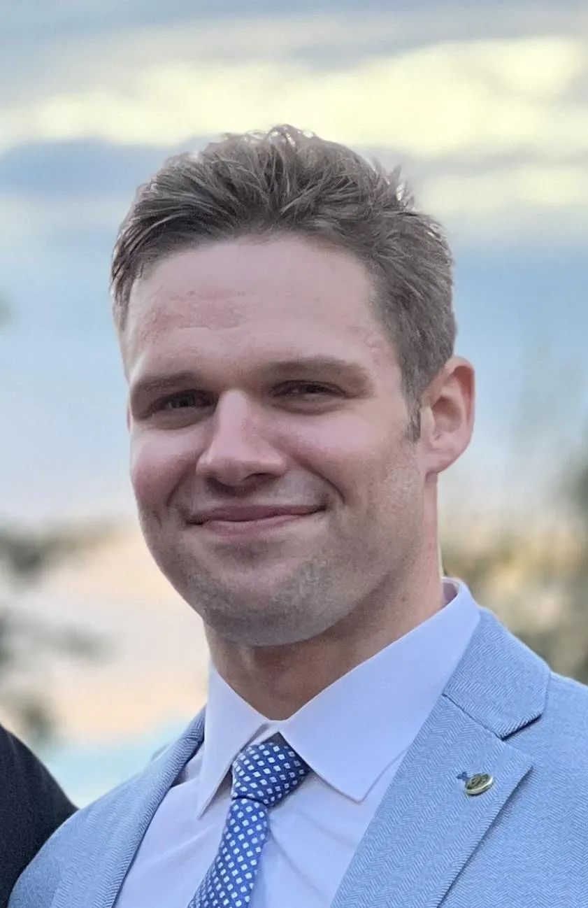 Steve Lutz, fitness coach, outdoors in a blue suit.