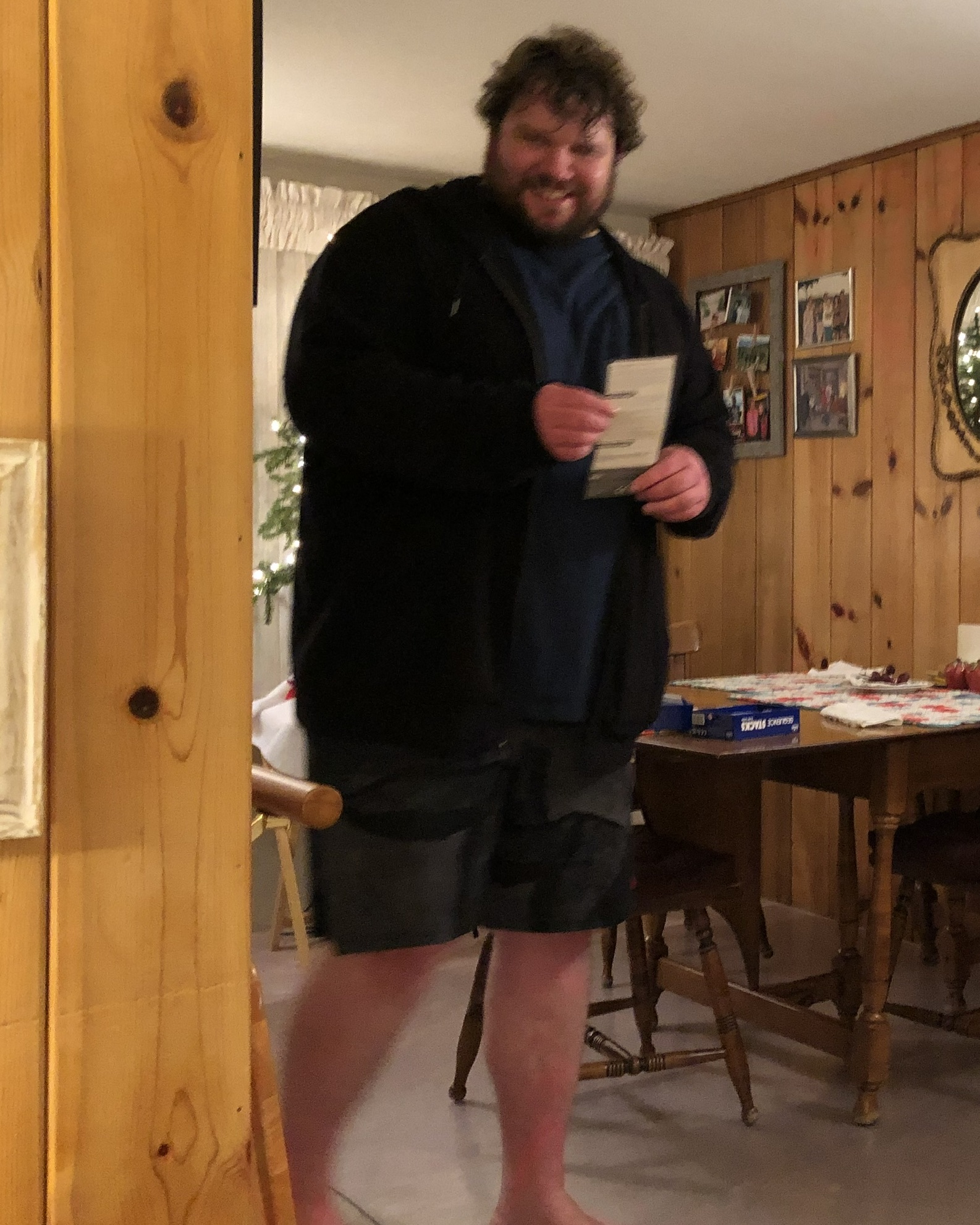 Steve Lutz before, standing indoors in a jacket and shorts.