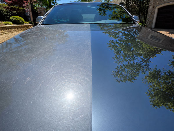 Before and after paint correction comparison on a luxury car hood in McLean VA