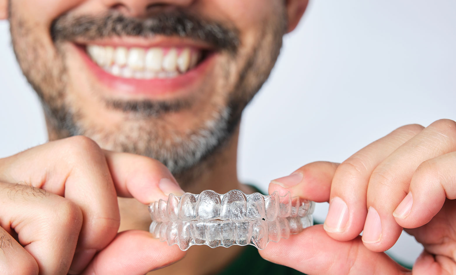 Woman holding invisalign