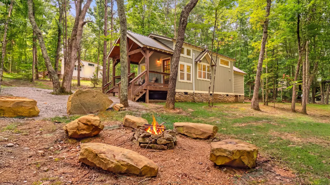 Highland Gulf Retreat cabin with a fire pit in the woods