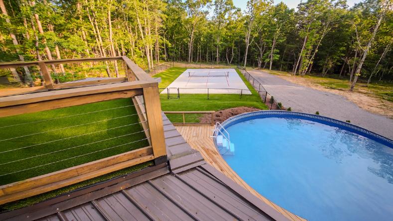 Outdoor pool beside the pickleball court at Highland Gulf Retreat