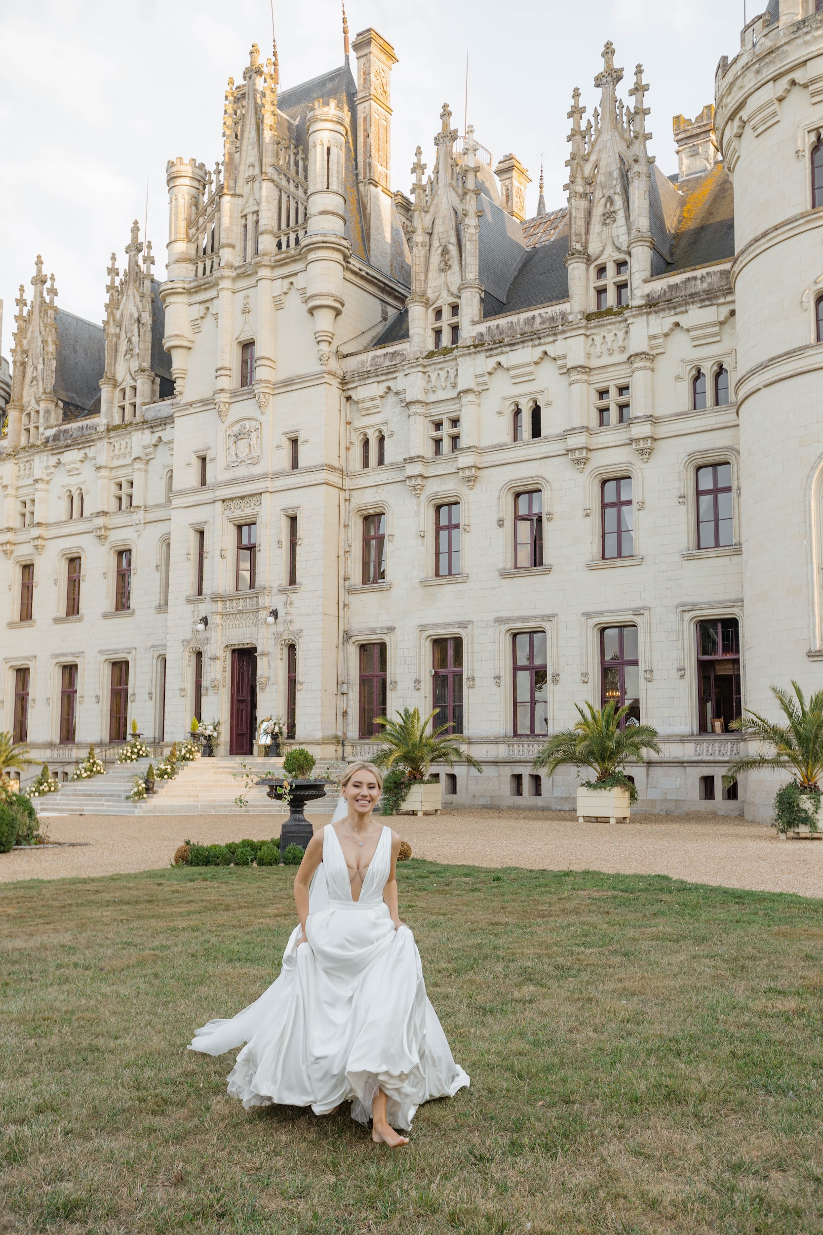 Bride in front of Château Challain during a luxury destination wedding in Challain-La-Potherie, Pays de la Loire, France Bride in front of Château Challain during a luxury destination wedding in Challain-La-Potherie, Pays de la Loire, France