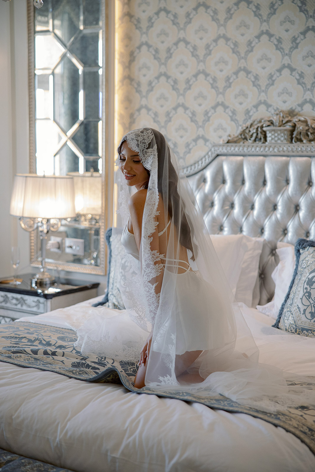 Bride in a lace veil during bridal morning at Raffles The Palm Dubai, photographed by Lubov Lisitsa. Luxury hotel wedding, editorial bridal portrait and destination wedding photography. Bride in a lace veil during bridal morning at Raffles The Palm Dubai, photographed by Lubov Lisitsa. Luxury hotel wedding, editorial bridal portrait and destination wedding photography.