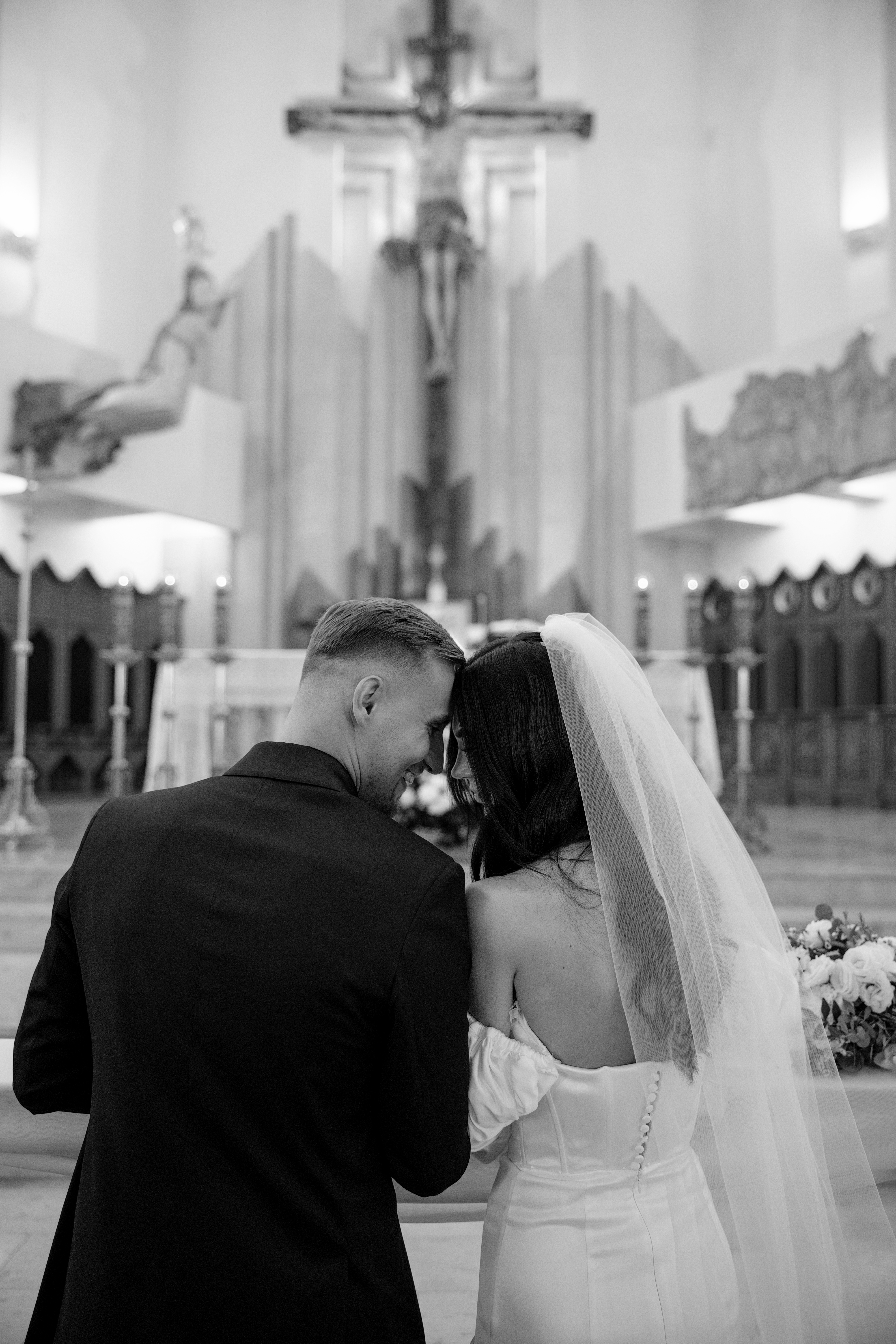 Bride and groom celebrating outside the church under a shower of rose petals in Warsaw