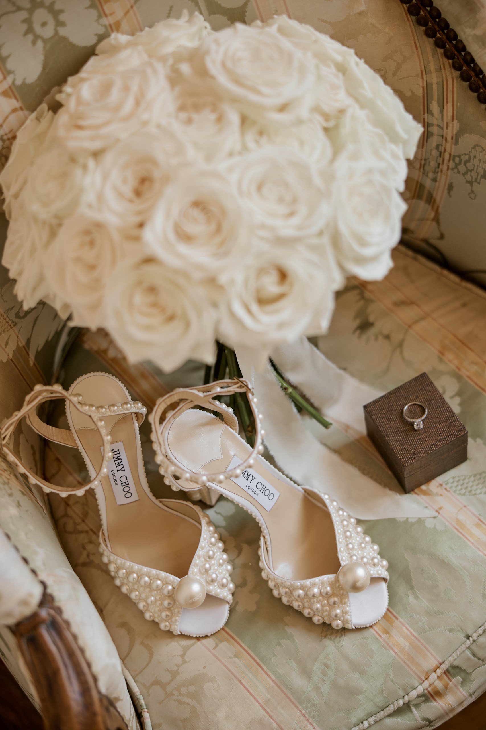 White bouquet, pearl Jimmy Choo shoes and diamond engagement ring for an elegant Milcha celebration in Dubai – photographed by Lubov Lisitsa
