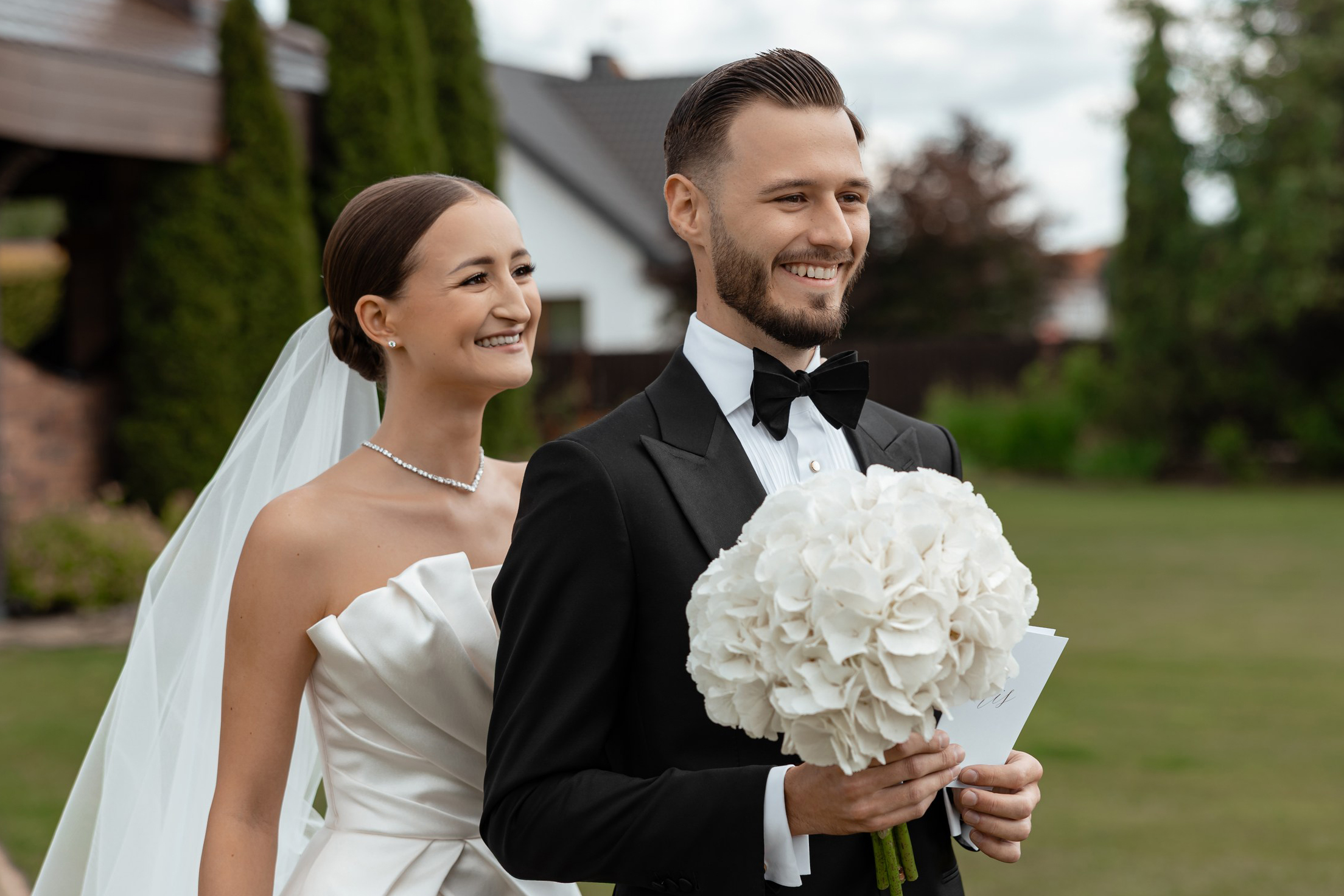 Smiling bride and groom during an elegant outdoor wedding in Warsaw, photographed by Lubov Lisitsa.