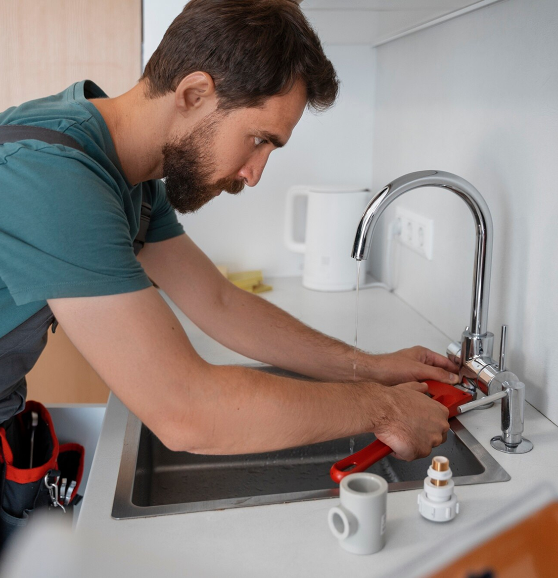 D.B. & Sons technician working on home plumbing in Avon, MA.