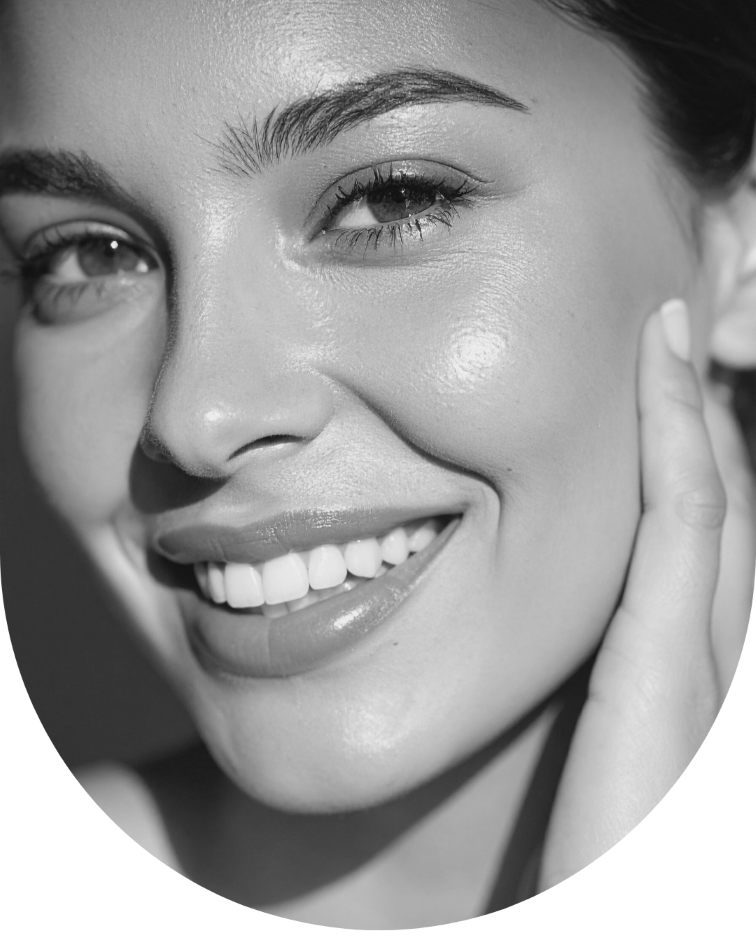 woman smiling after Glisten Haus beauty treatment