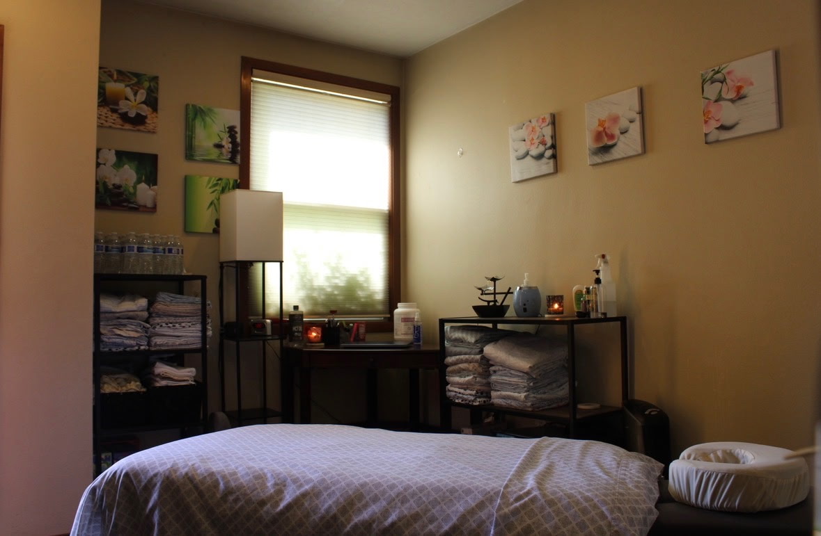 Licensed massage therapist delivering focused therapeutic care