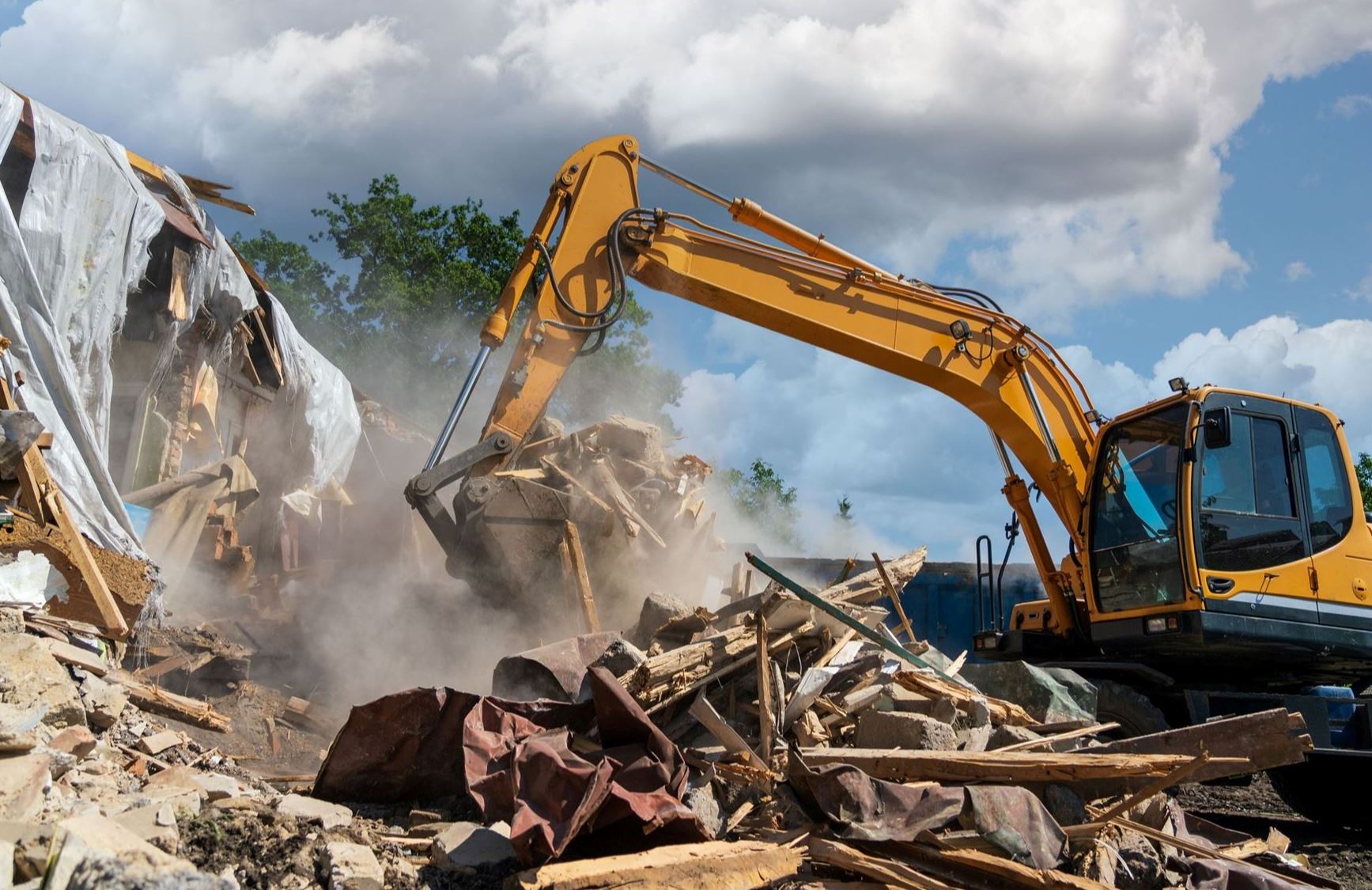 Excavator demolishing a structure during a demolition project