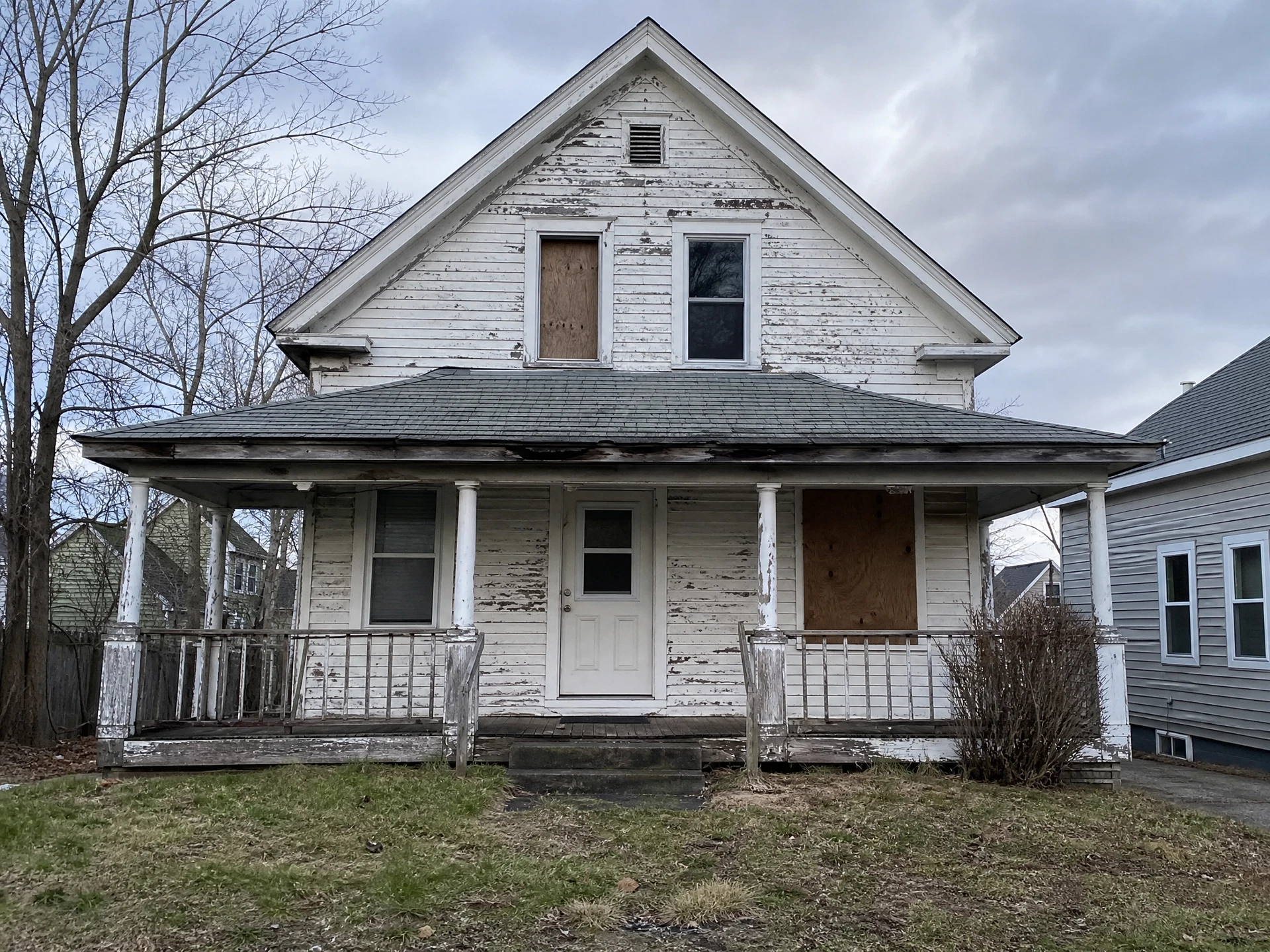 Distressed two-story clapboard house in Portland, Maine