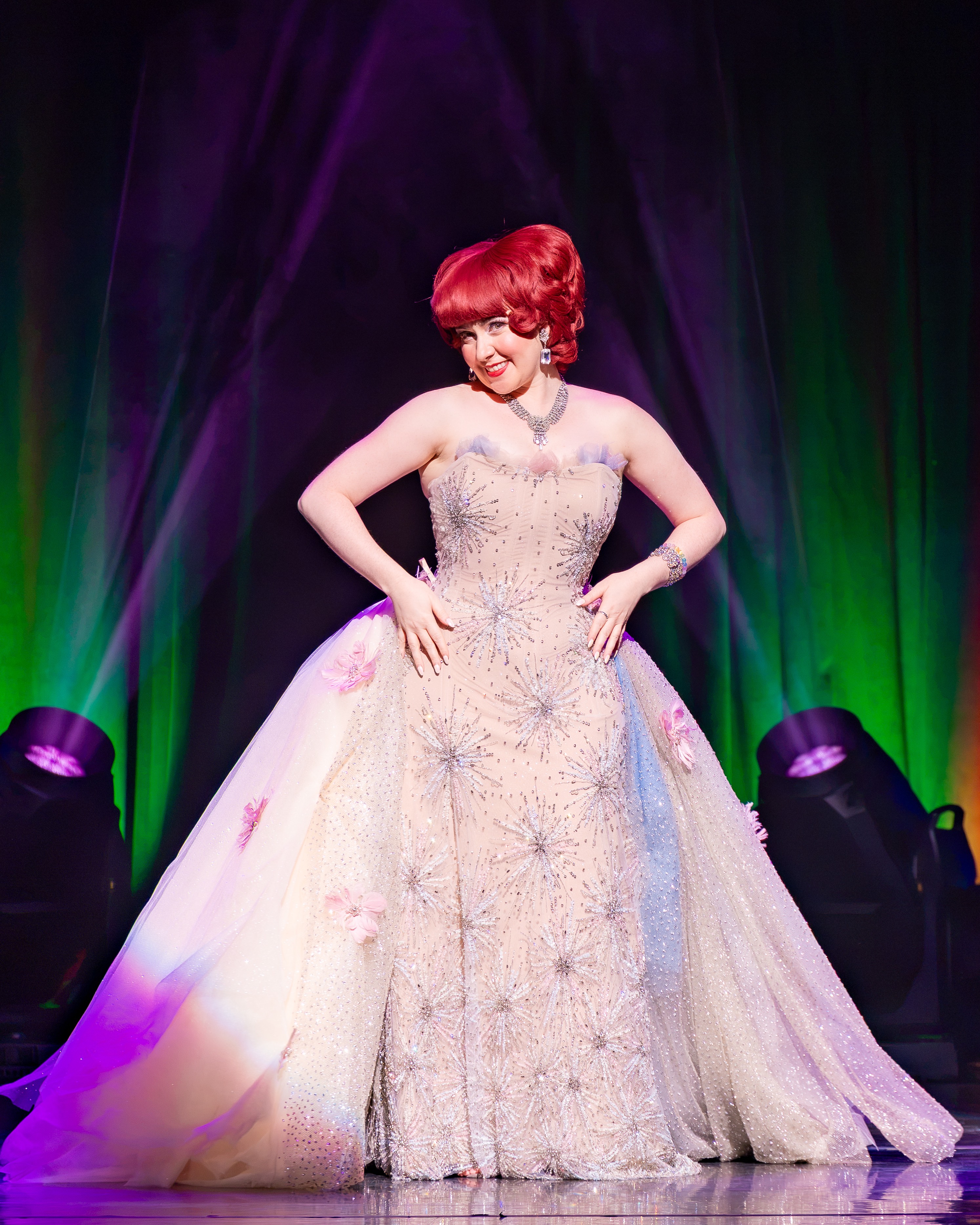 Custom strapless gown with sequin starbursts and a pink tulle overskirt, on stage