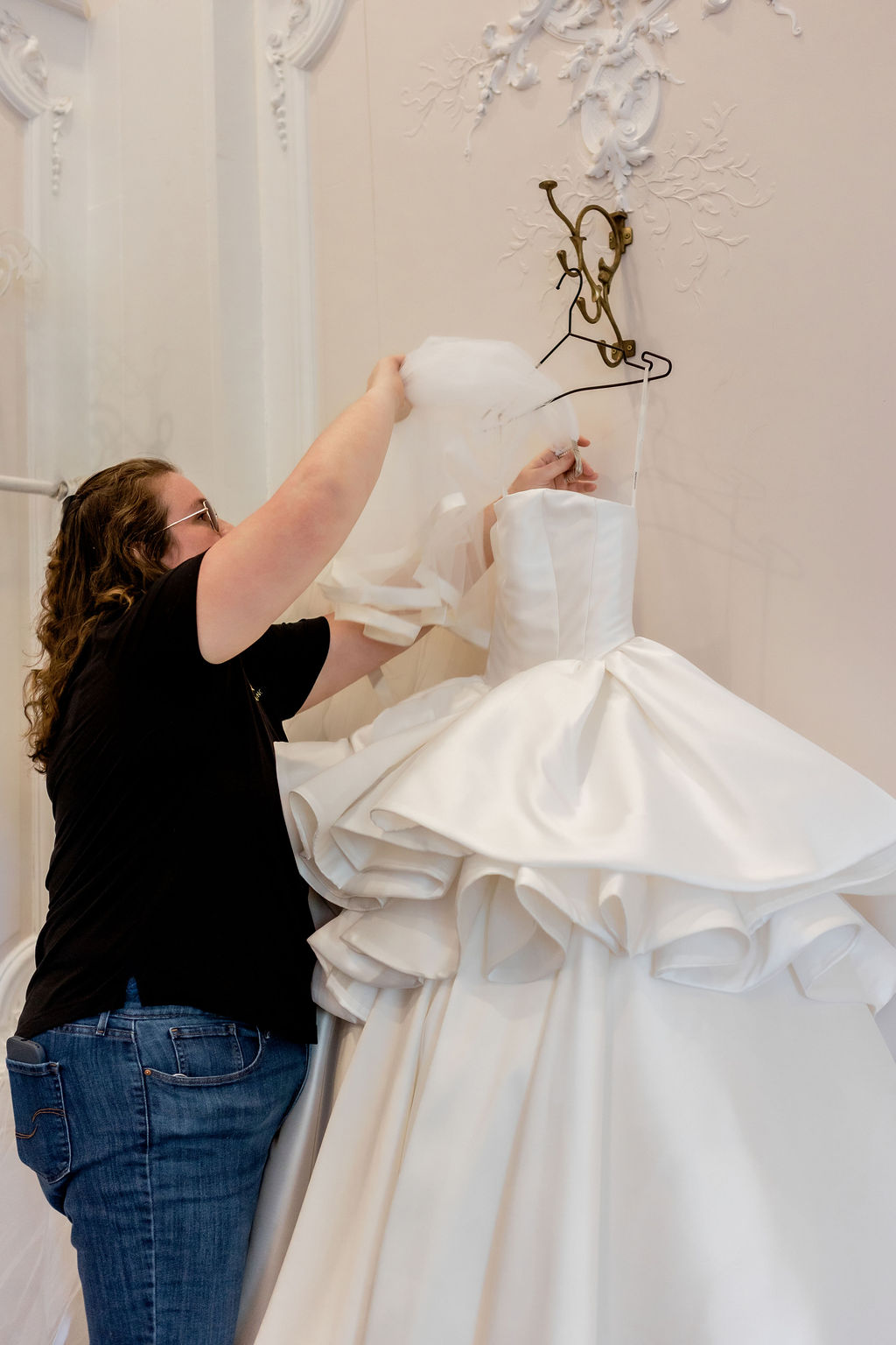 Hanging a veil with the wedding gown at a Houston-area venue