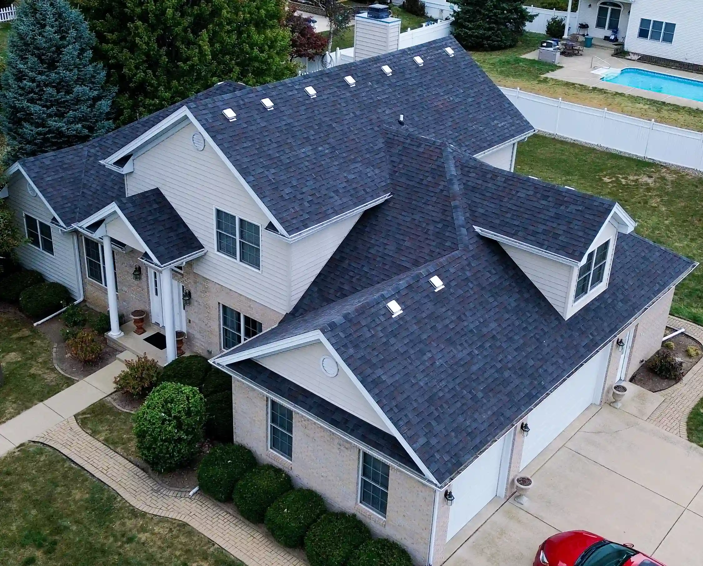 Emergency roof repair in progress on a residential home in Wilmington Illinois with roofing crew securing damaged shingles