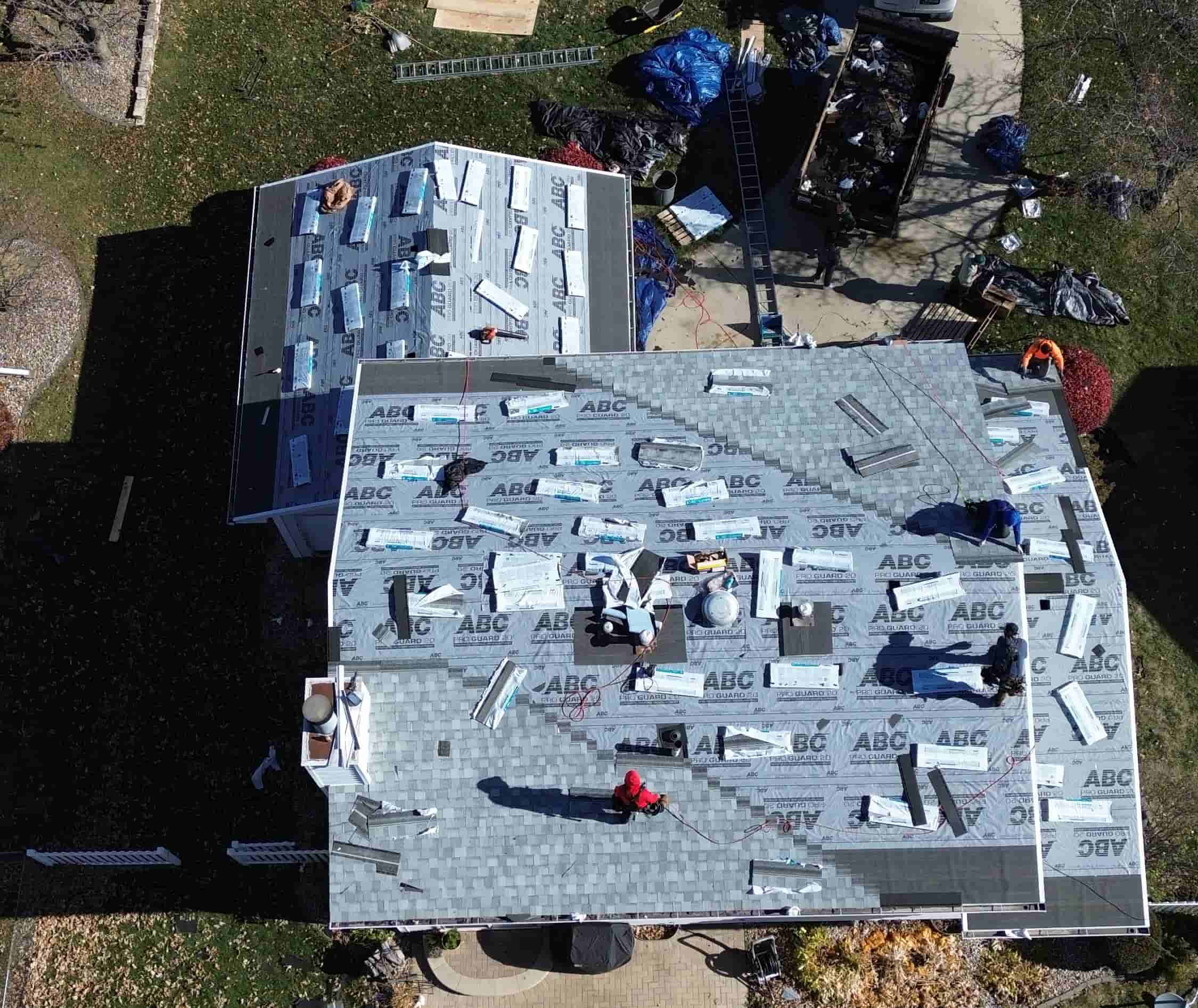 Aerial view of residential roof installation in progress by roofing experts providing professional and reliable home roofing solutions