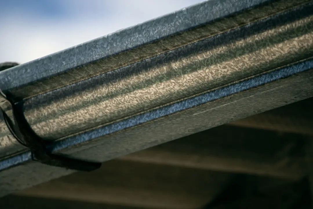 Close up of gutter system controlling rainwater runoff to prevent soil erosion and landscaping damage around a home