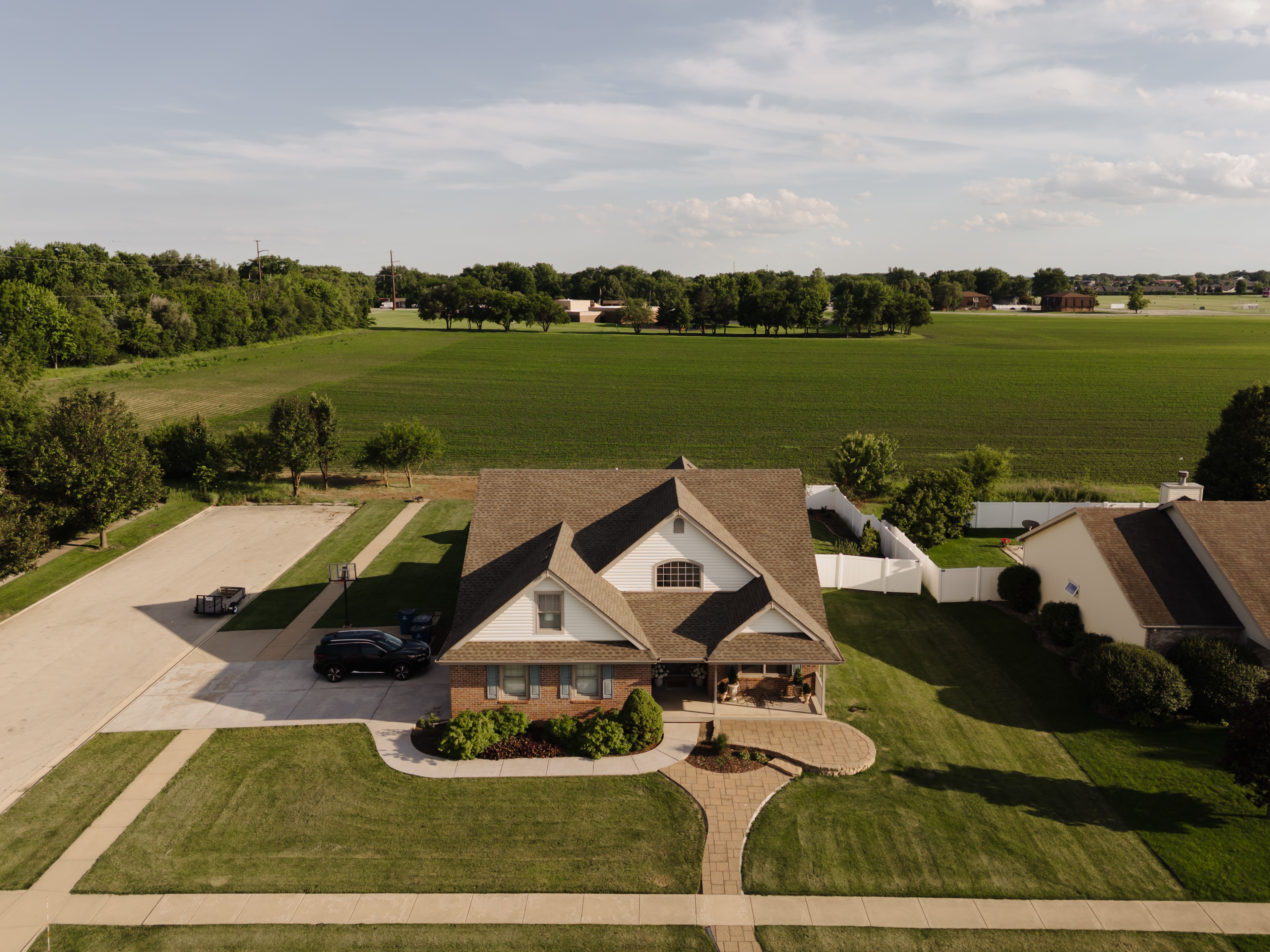 Aerial view of professional roof repair on a residential shingle roof completed with quality materials for long term protection in Illinois