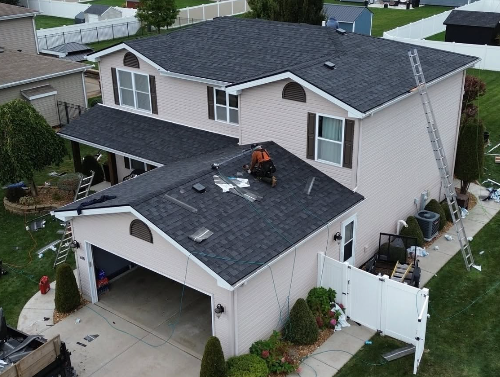 Emergency roof repair in progress on a residential home in Frankfort Illinois with roofing crew securing damaged shingles
