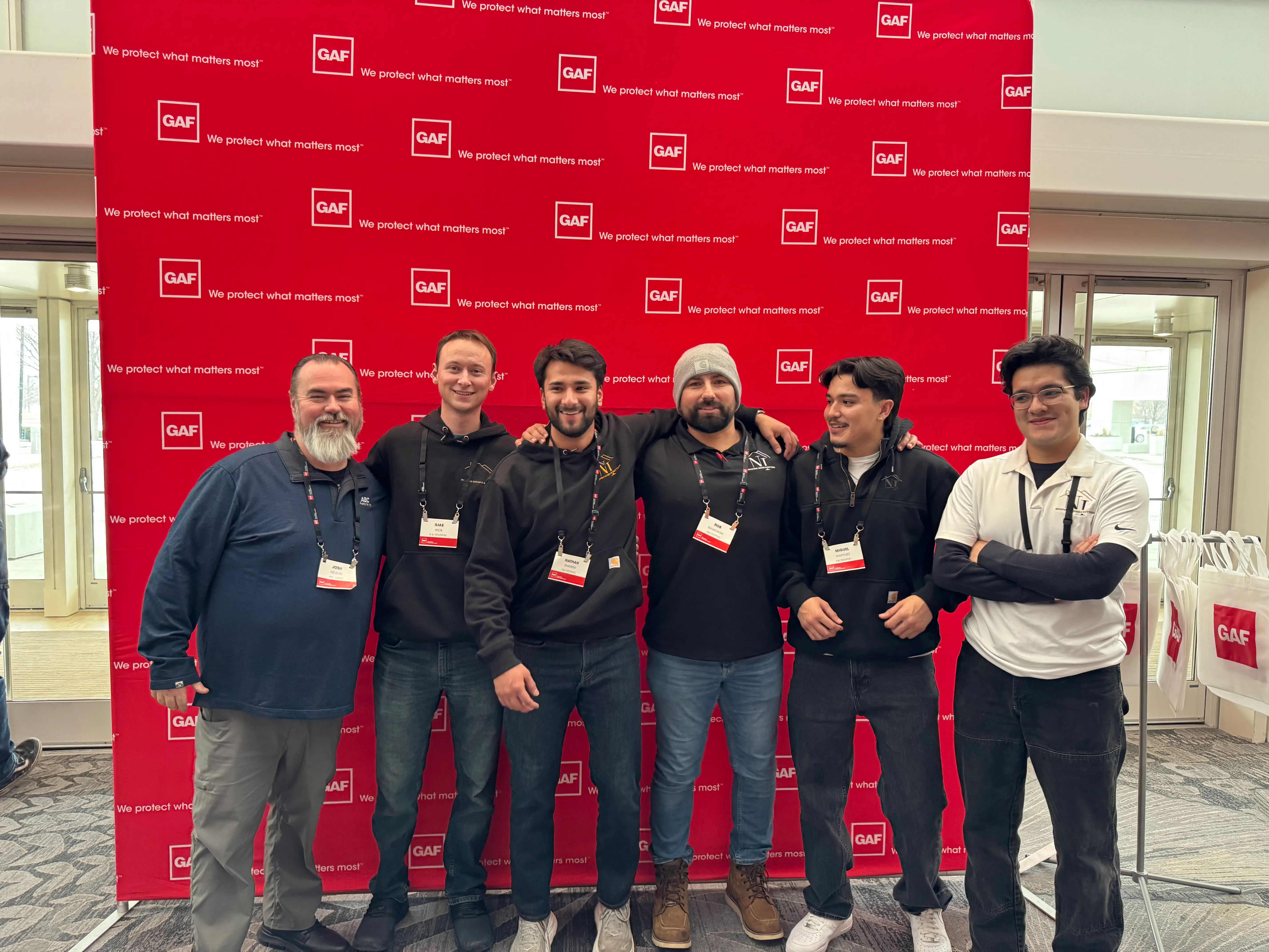 N&I Roofing team members with a supply partner at a GAF roofing contractor event, serving Kankakee County, IL