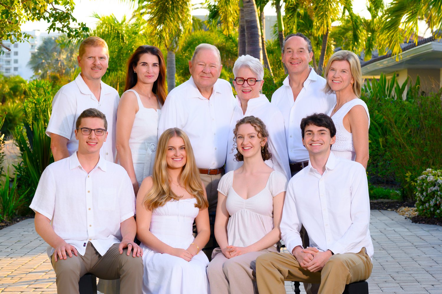 Family in white in a tropical garden setting