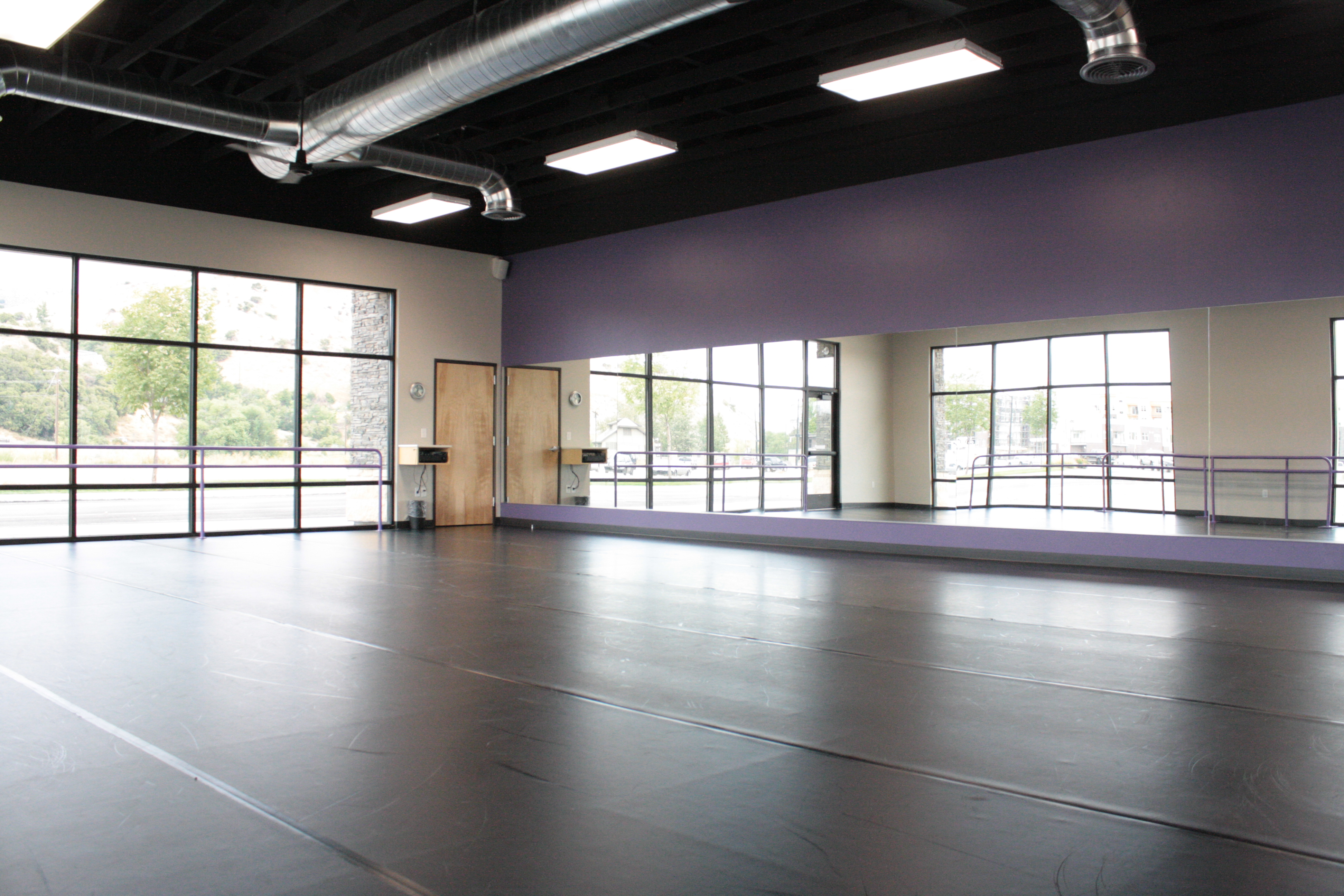 studio with mirrors & purple wall & ballet barres