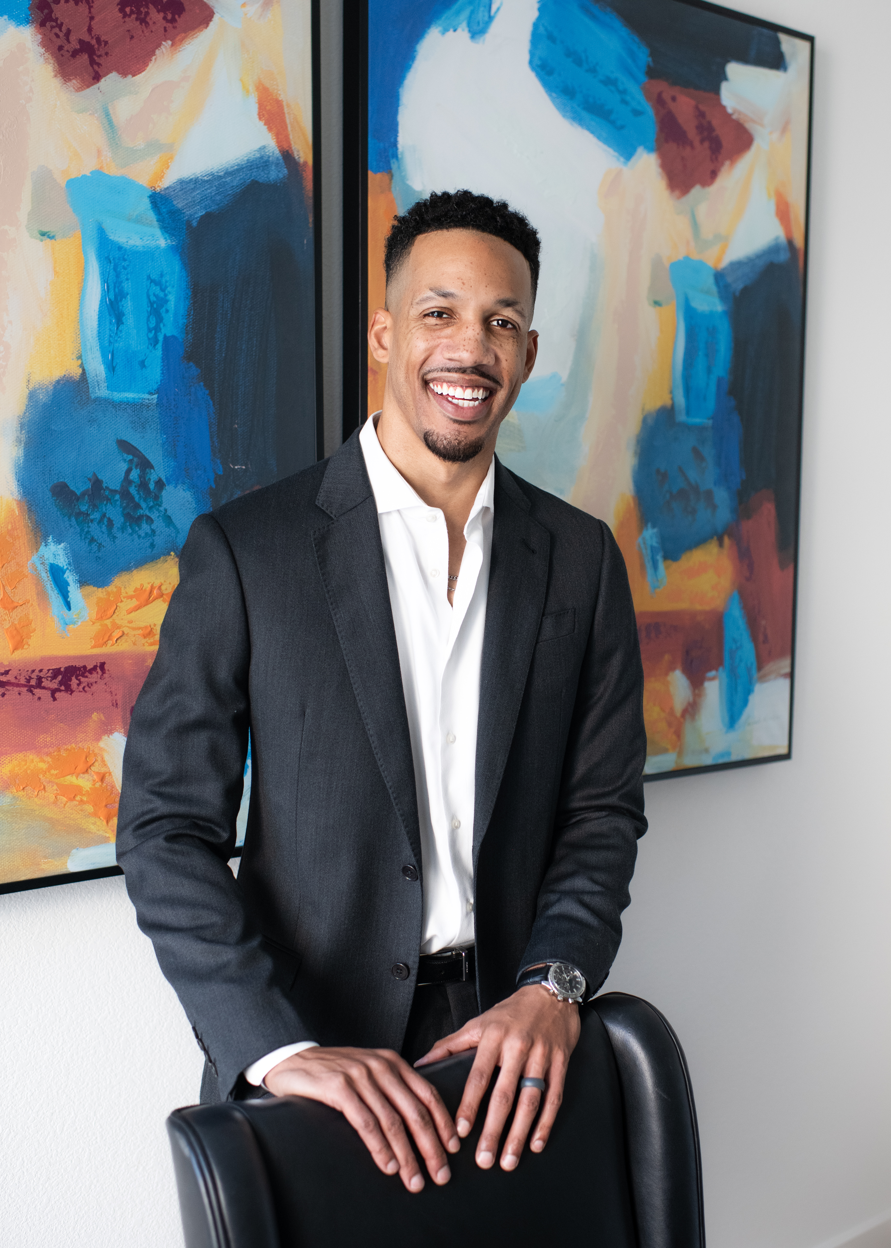Zacc Mitchell, licensed DFW REALTOR and Addison barber, sitting in a chair