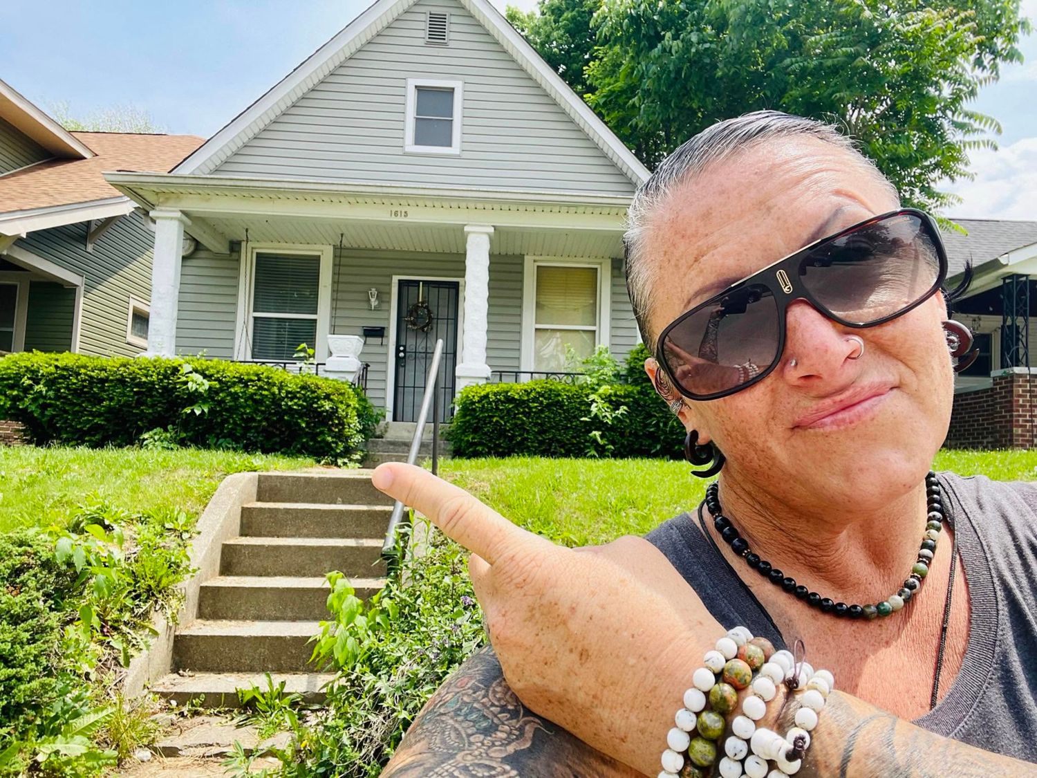 Jen in front of a property