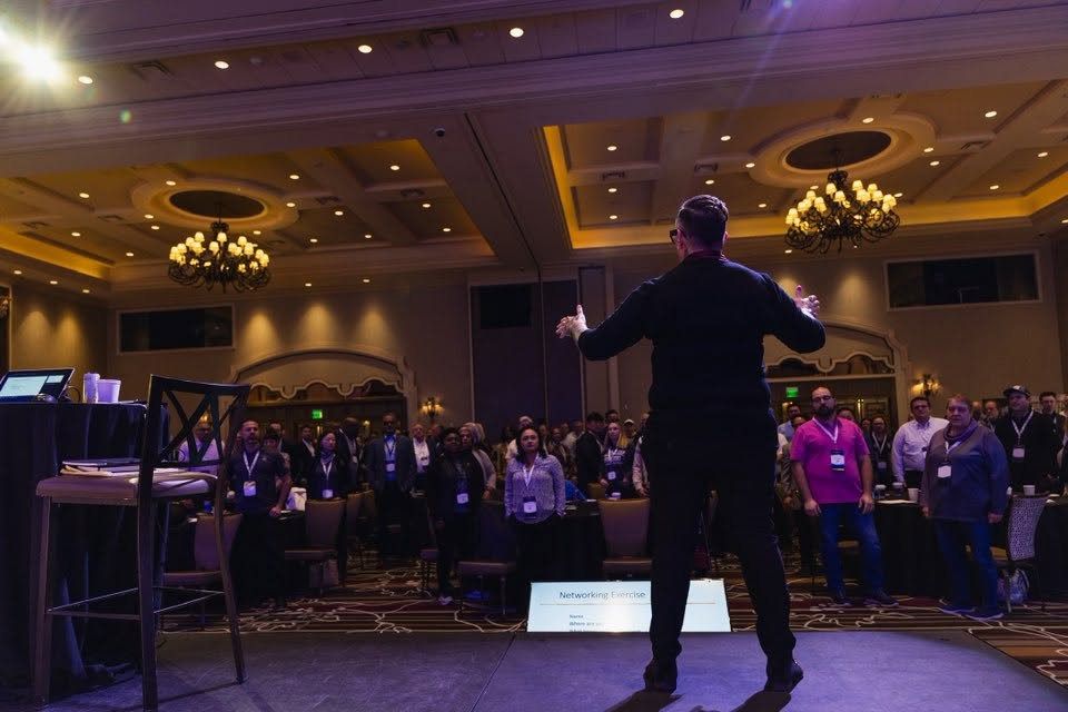 Jen speaking to a ballroom