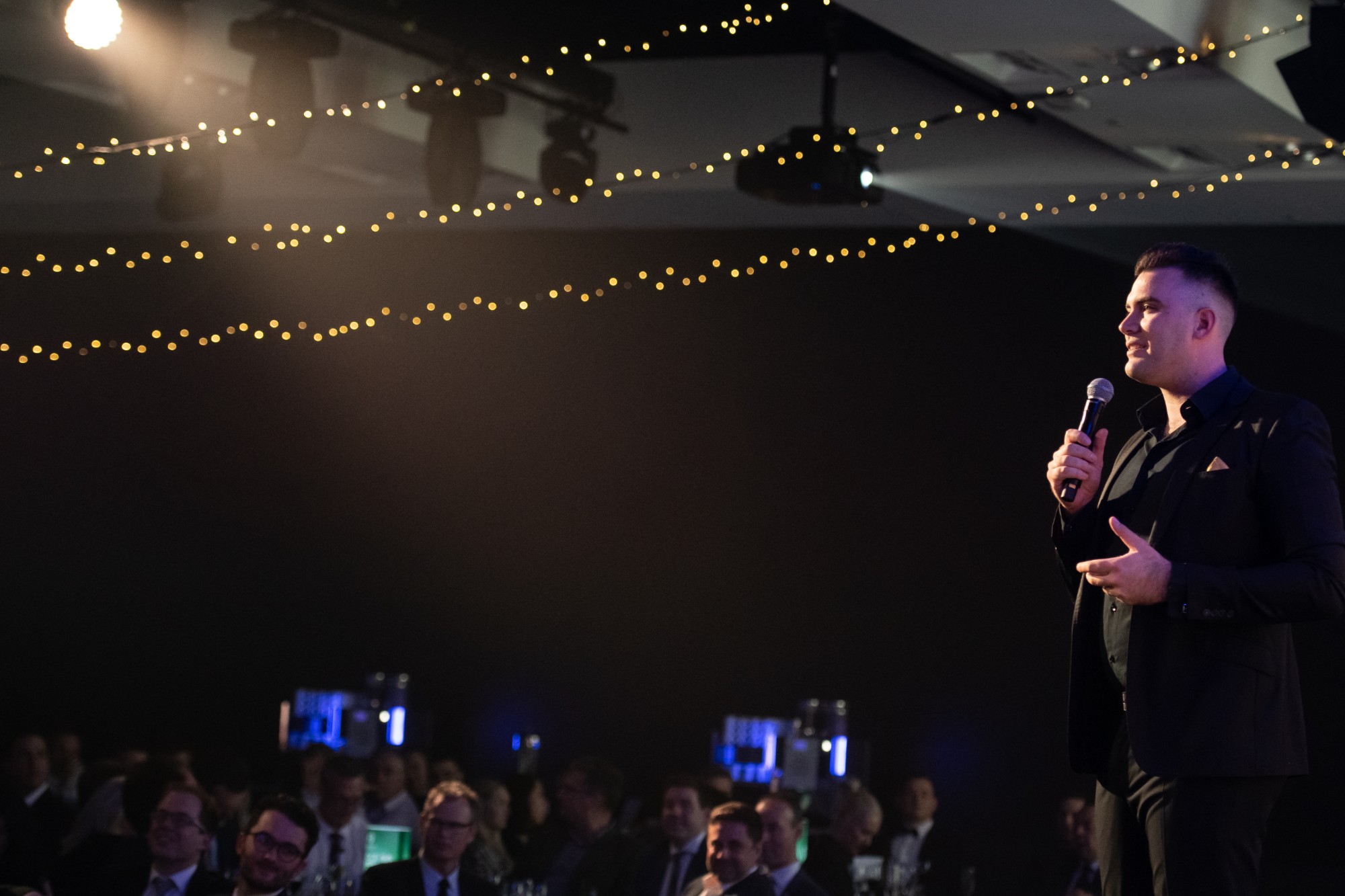 Isaac speaking to a ballroom audience